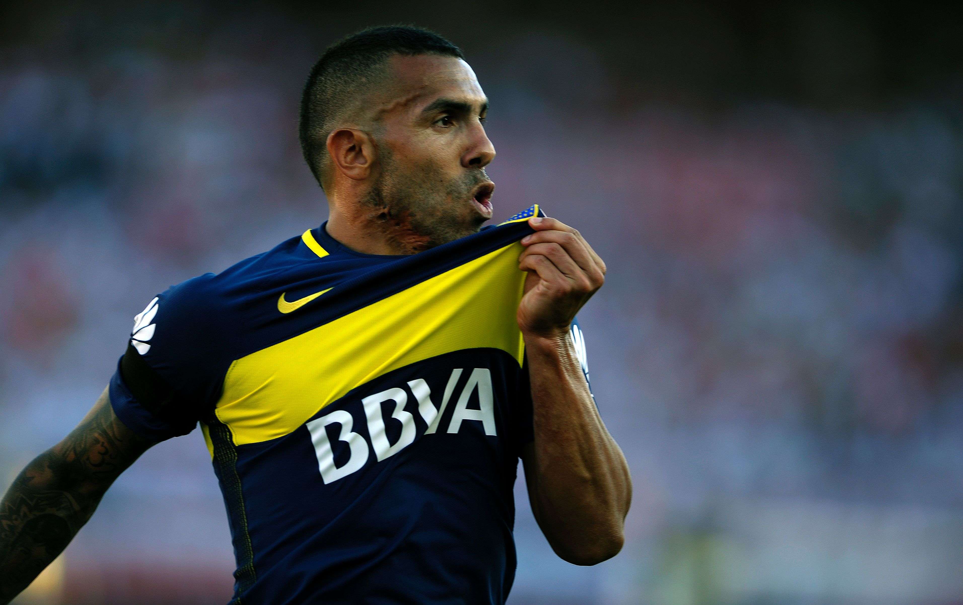 Boca Juniors' forward Carlos Tevez kisses the badge after scoring against city rivals River Plate at the weekend. Photo: AFP