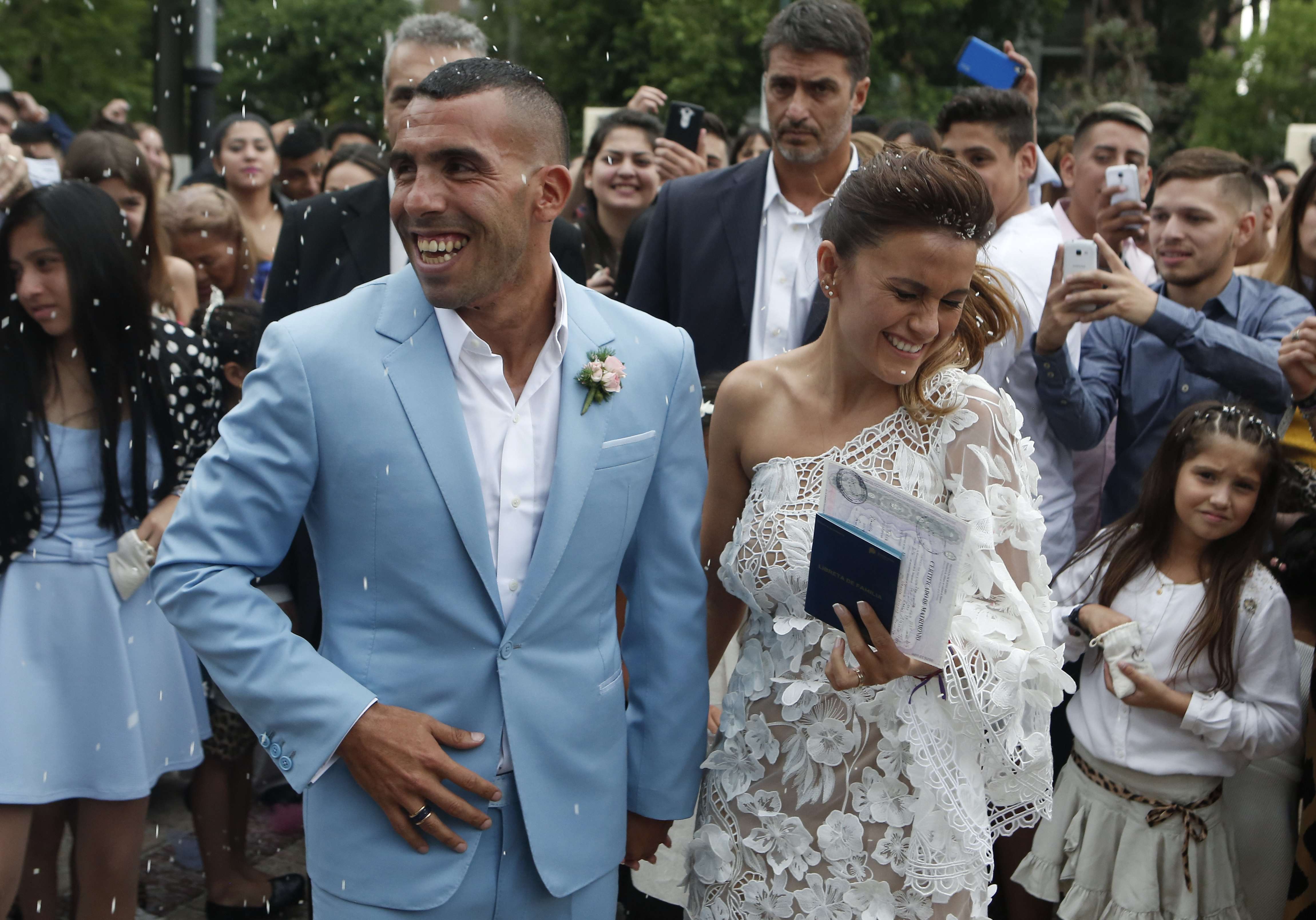 Carlos Tevez and his wife Vanesa Mansilla exit the church after their wedding in Buenos Aires. Photo: AP