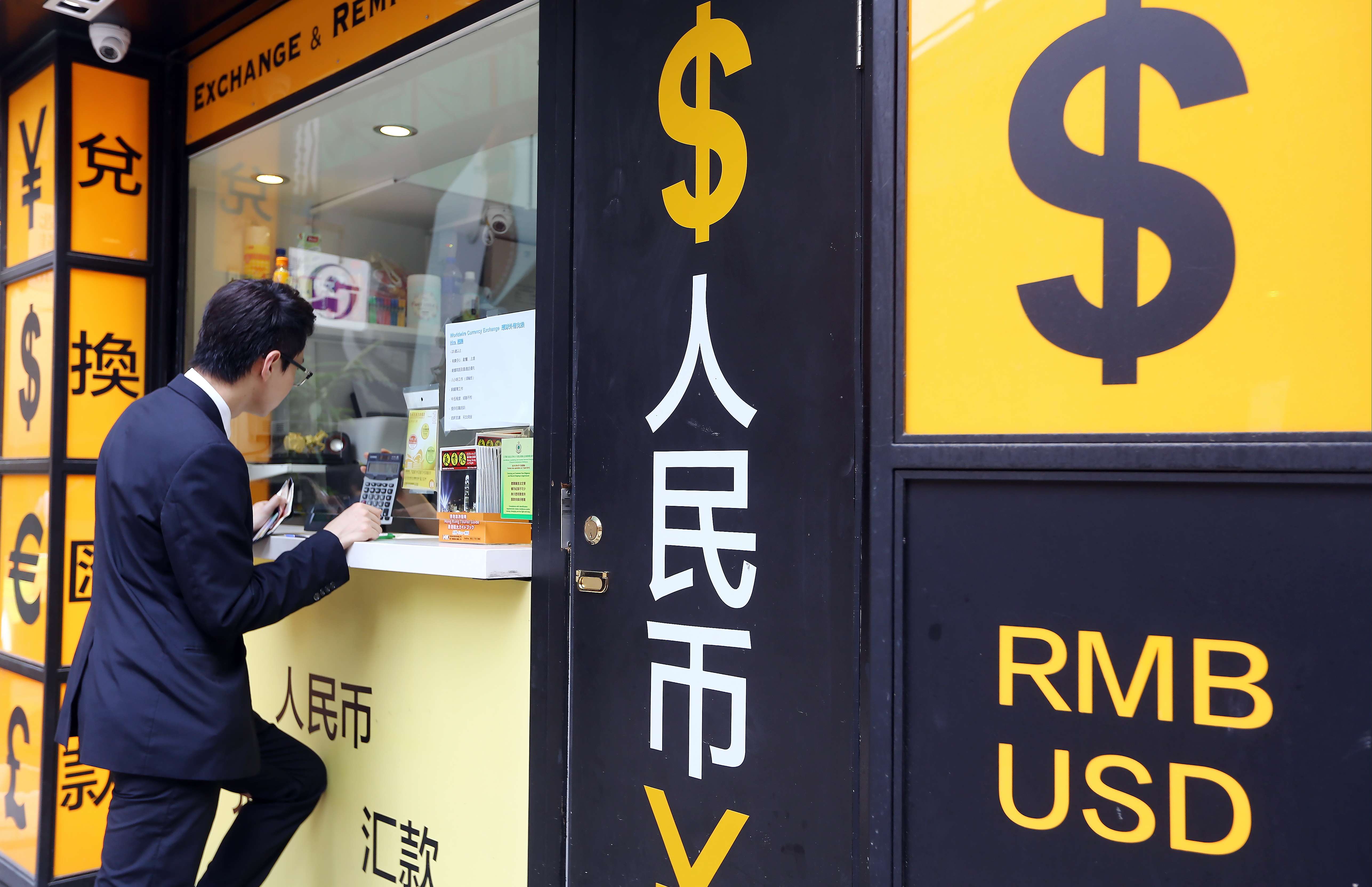 A man is seen at a currency exchange store in Hong Kong. Photo: Sam Tsang