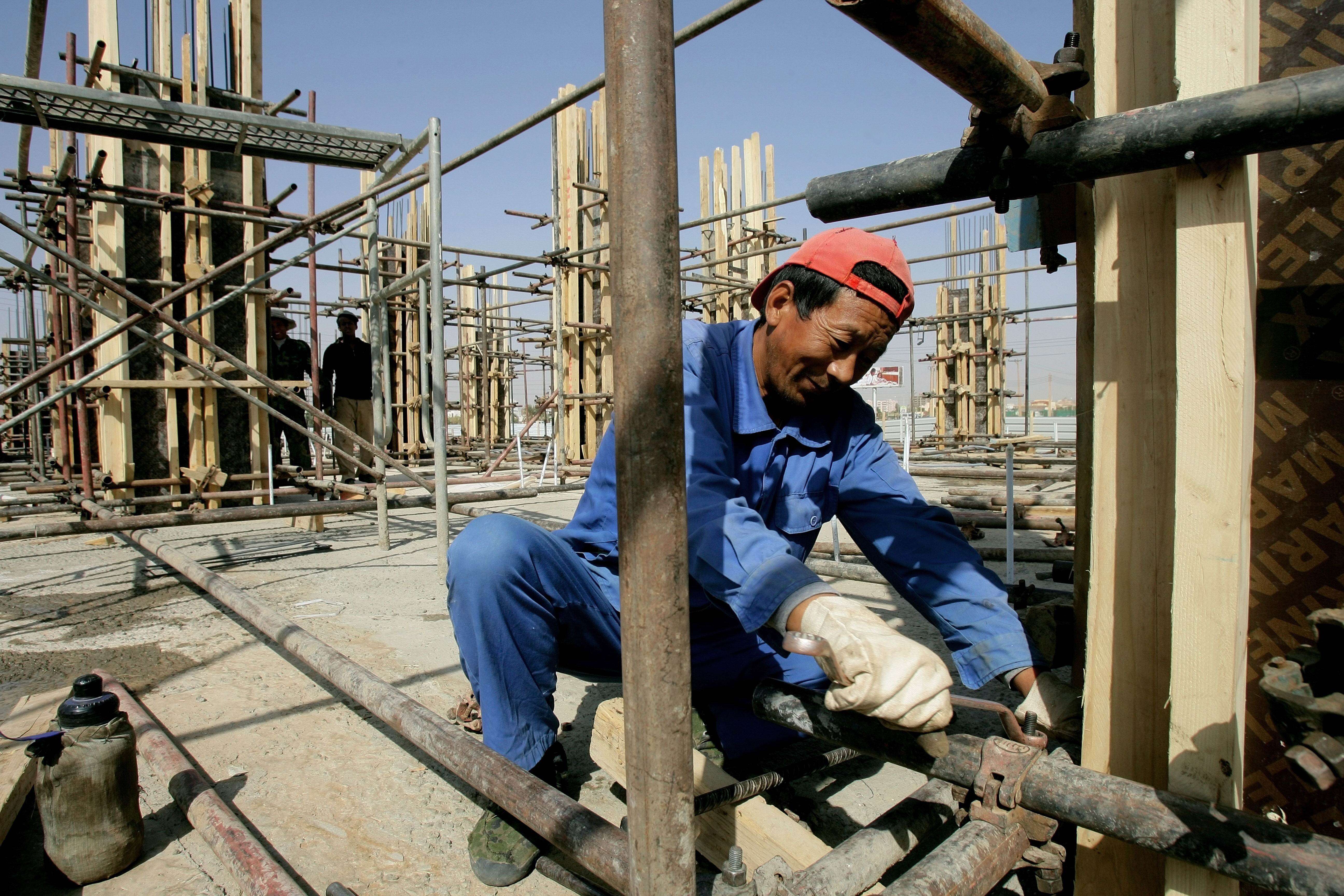 A Chinese worker fixes pipes at a construction site in Sudan’s capital Khartoum in February 2012. China is a major funder of infrastructure projects in Africa. Photo: AFP