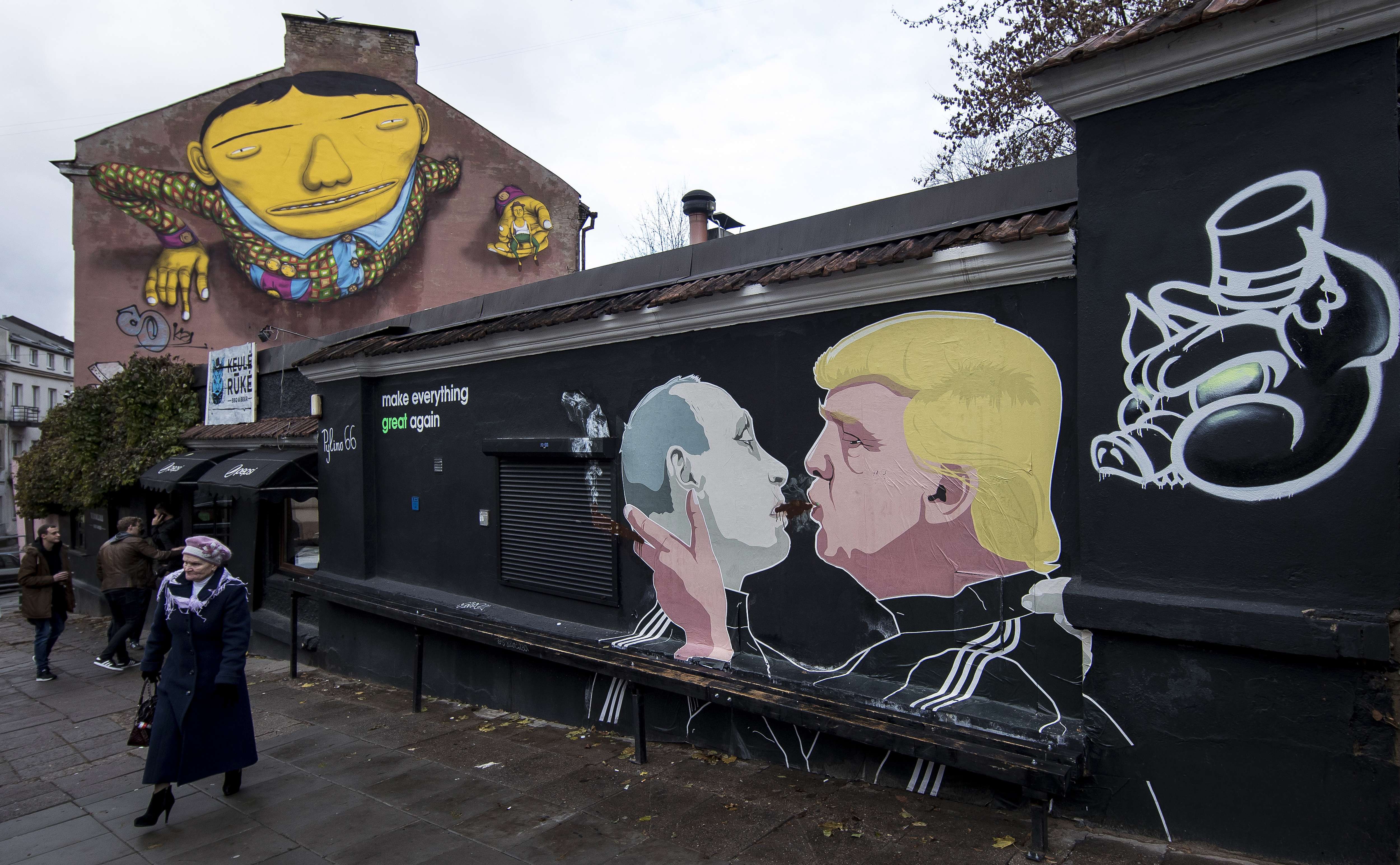 Graffiti artwork depicts Russian President Vladimir Putin and then Republican presidential candidate Donald Trump outside a bar in the old town in Vilnius, Lithuania, on October 30. Photo: AP