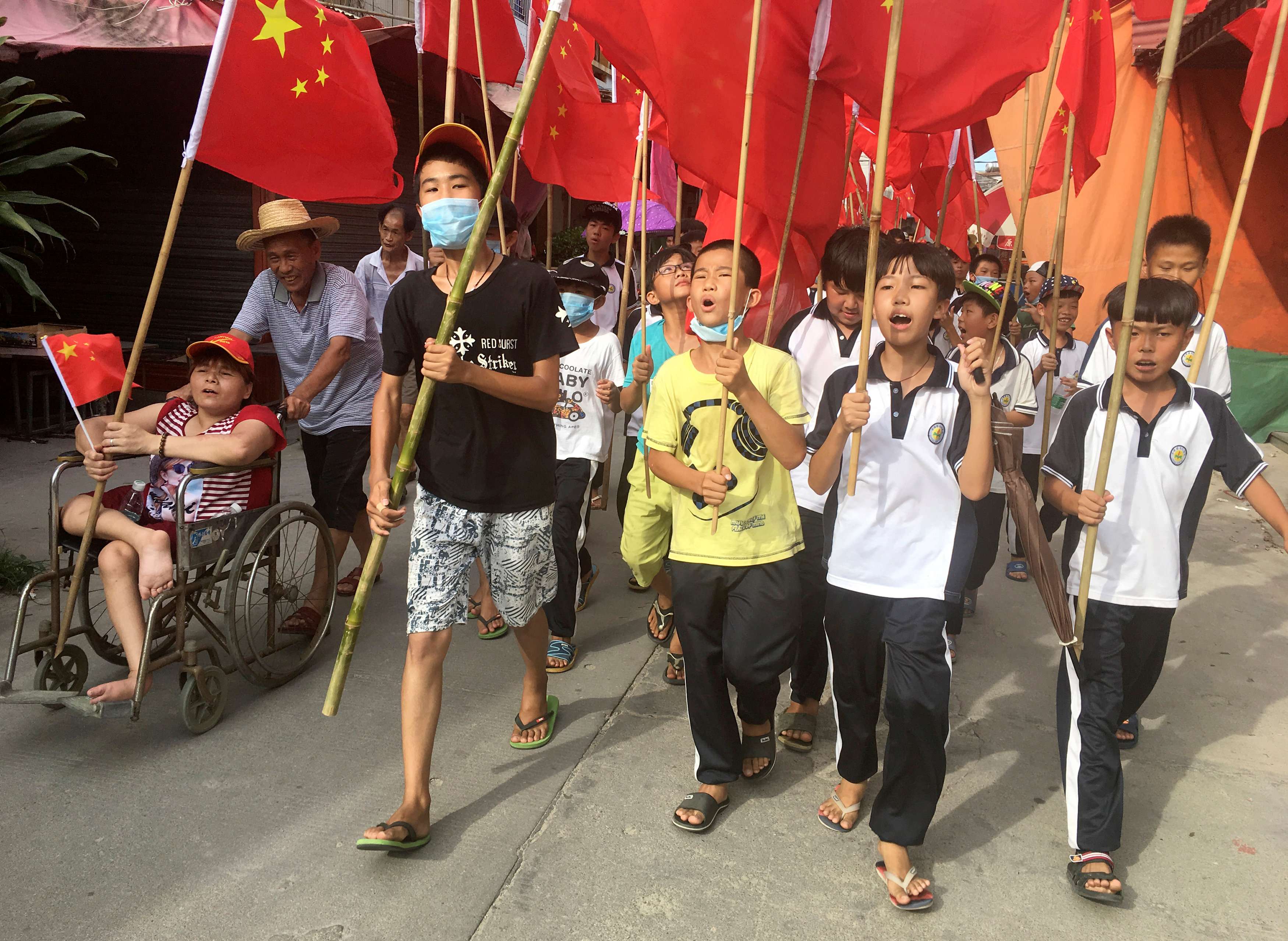 Villagers including schoolchildren took part in a protest in June, demanding the release of their village chief Lin Zuluan, in Wukan. Photo: Reuters
