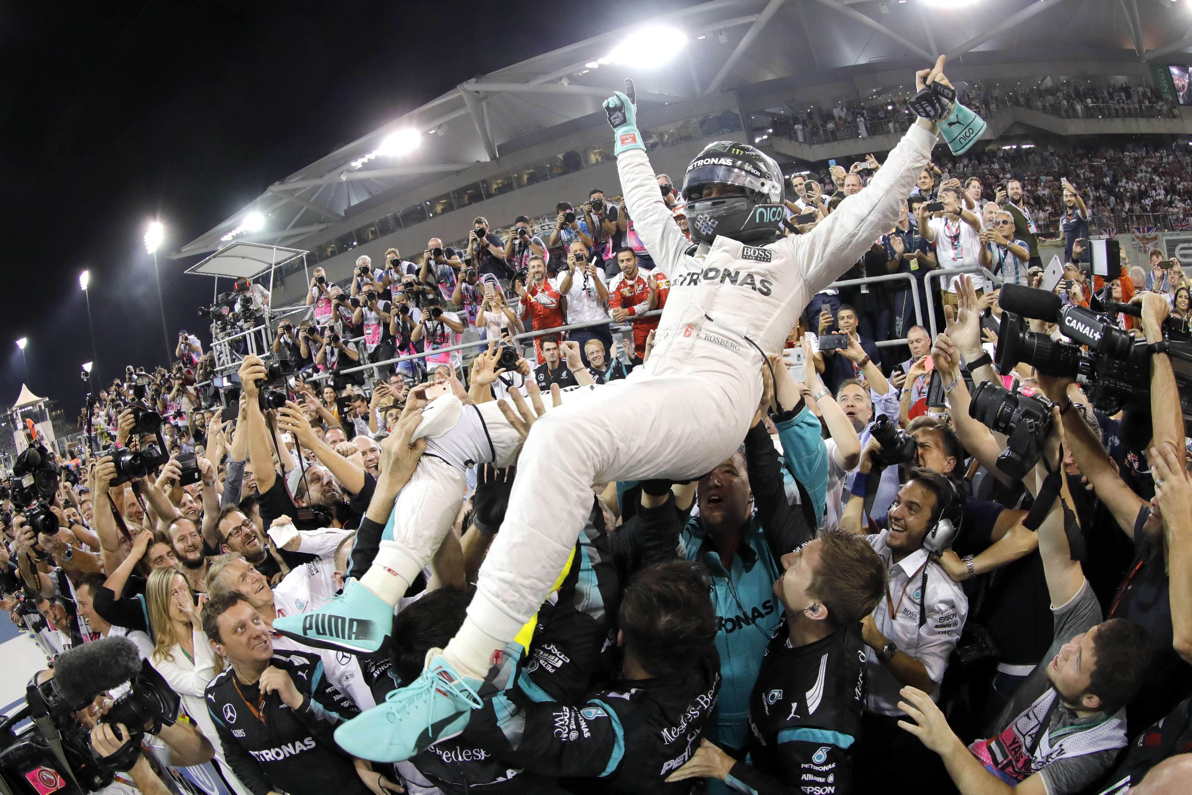 German Formula One driver Nico Rosberg celebrates with his team after winning the Formula One World Championship. Photo: EPA