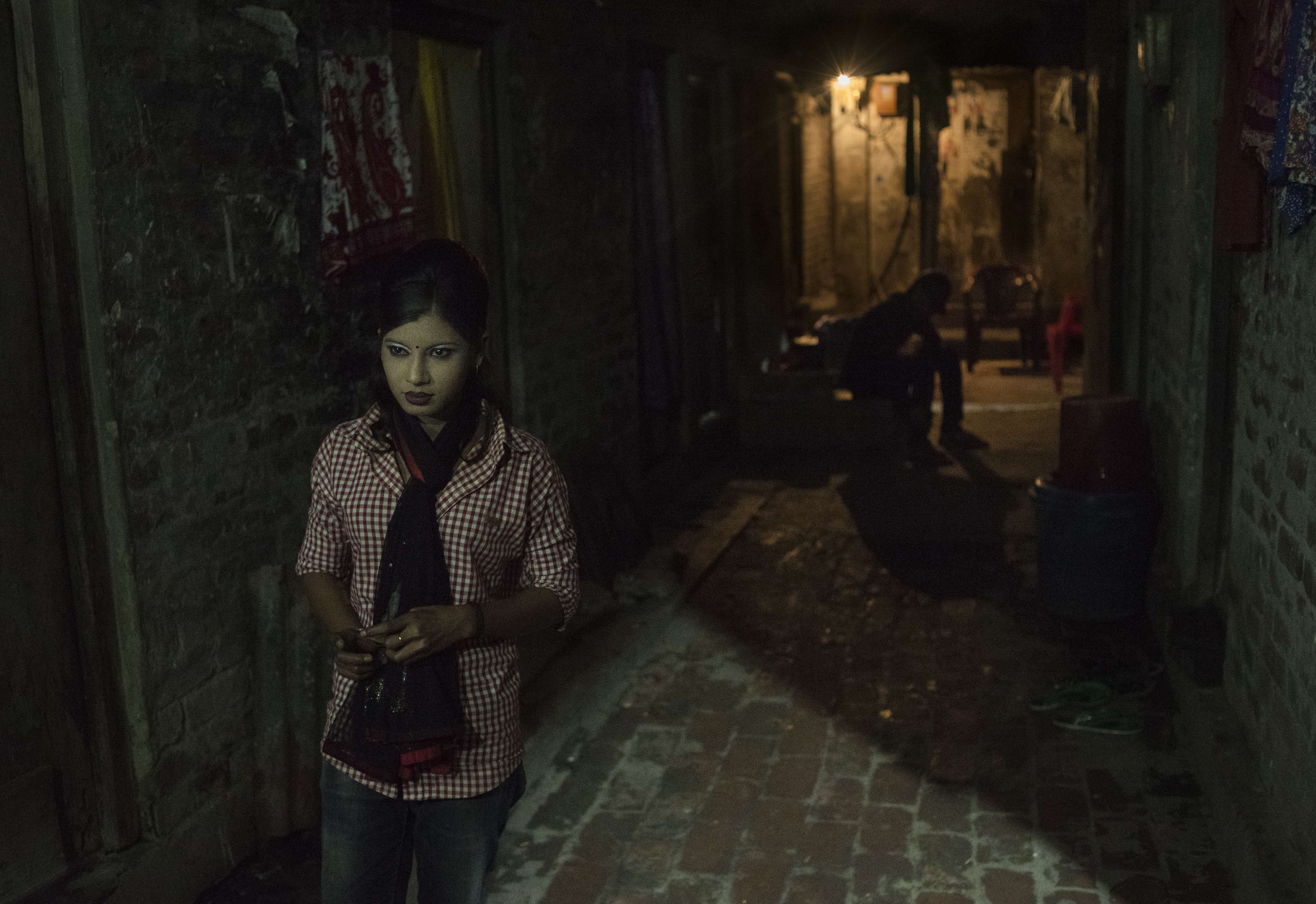 Sex worker Bristi walks a hallway near her room in the Town Brothel, in Faridpur, Bangladesh. Pictures: Miguel Candela