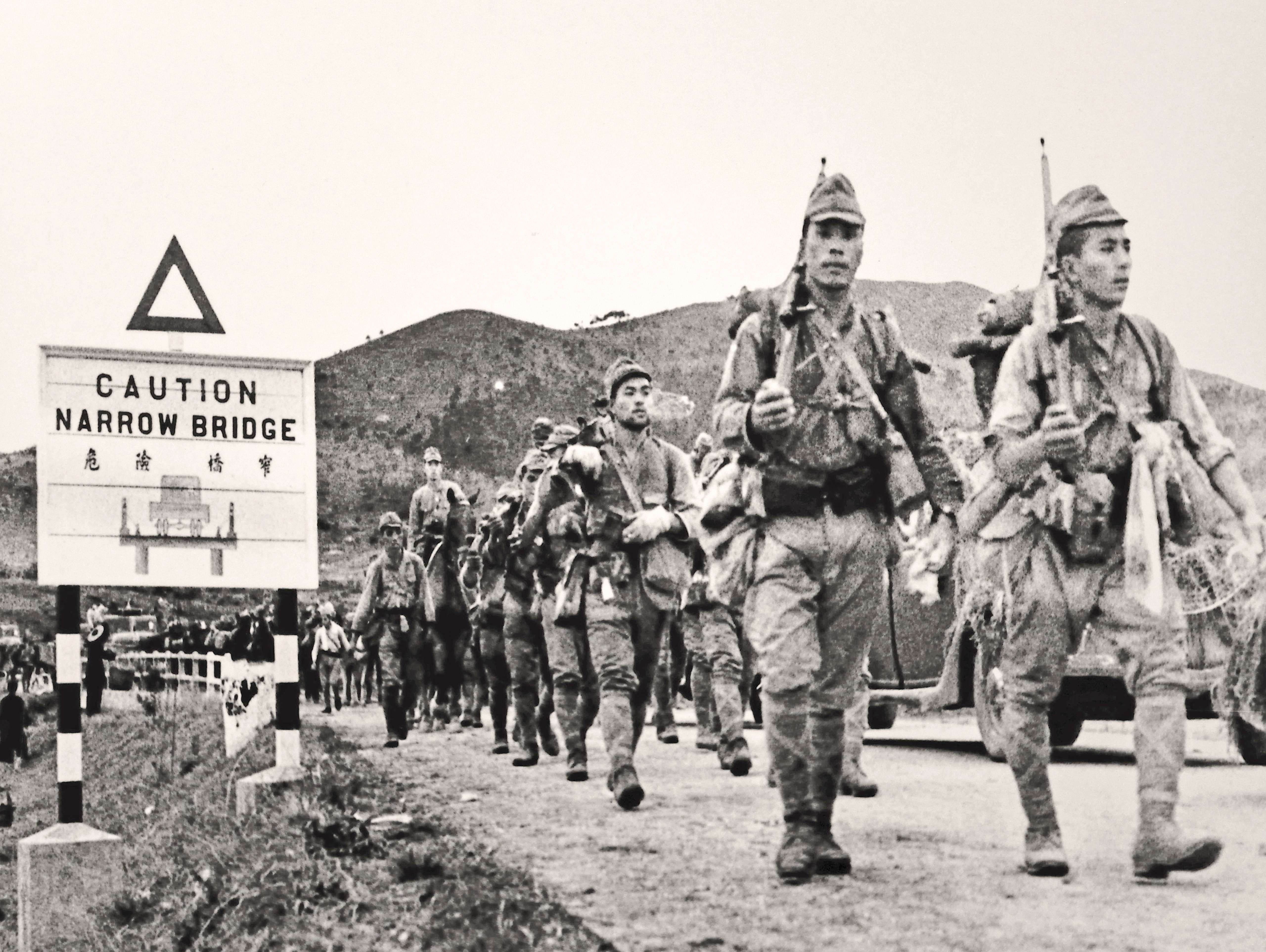 Japanese troops march across the border into Hong Kong. Photo: Alamy Stock Photo
