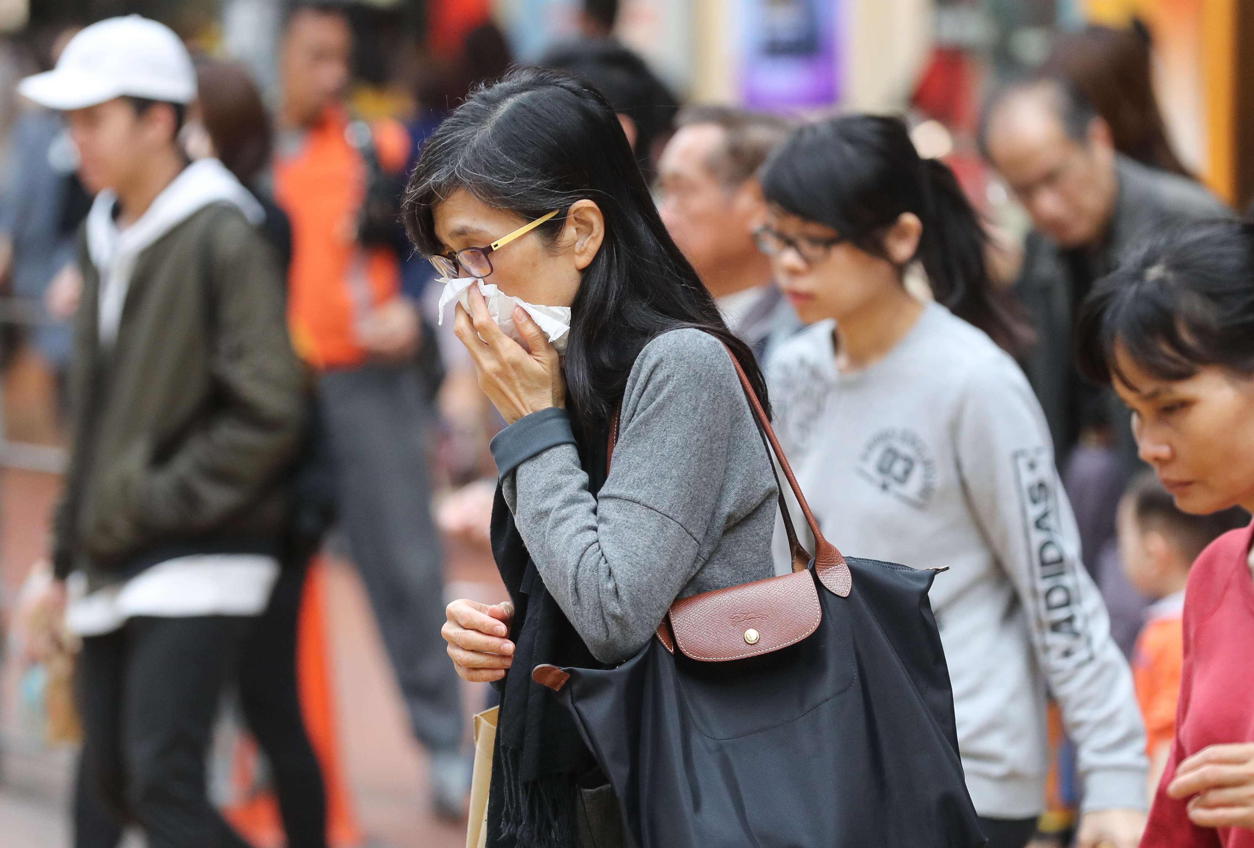 People wear masks on the streets in Causeway Bay as winter sets in. Photo: Edward Wong