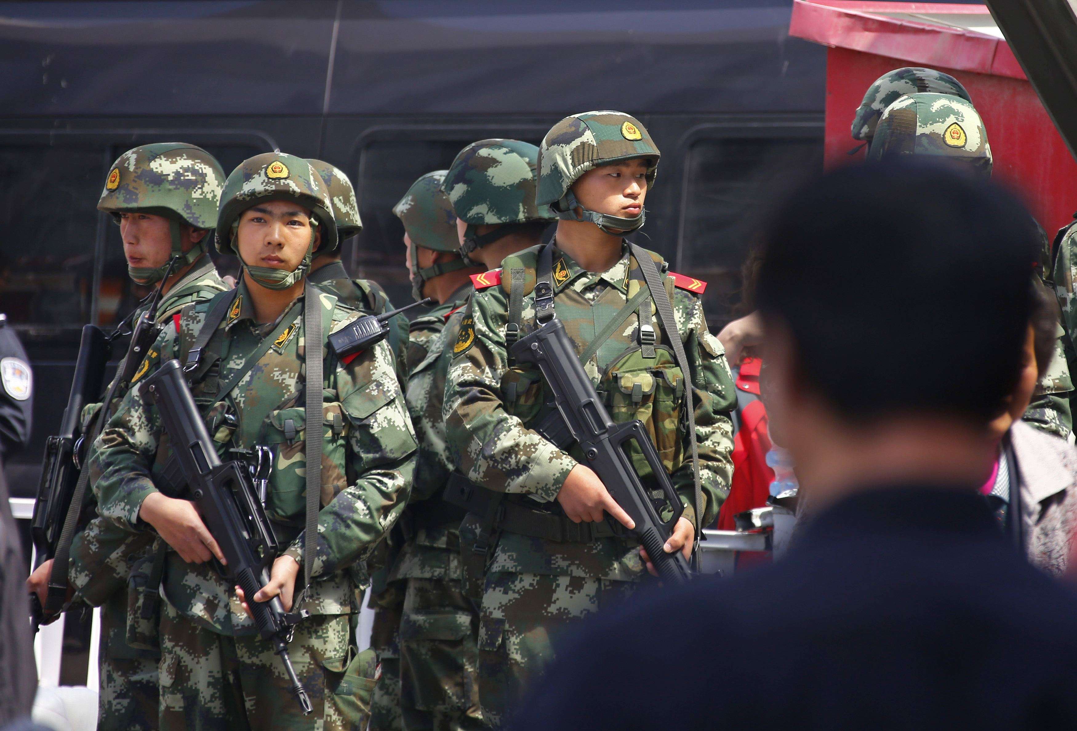 A file picture of paramilitary policemen standing guard at a railway station in Urumqi in Xinjiang. Photo: Reuters