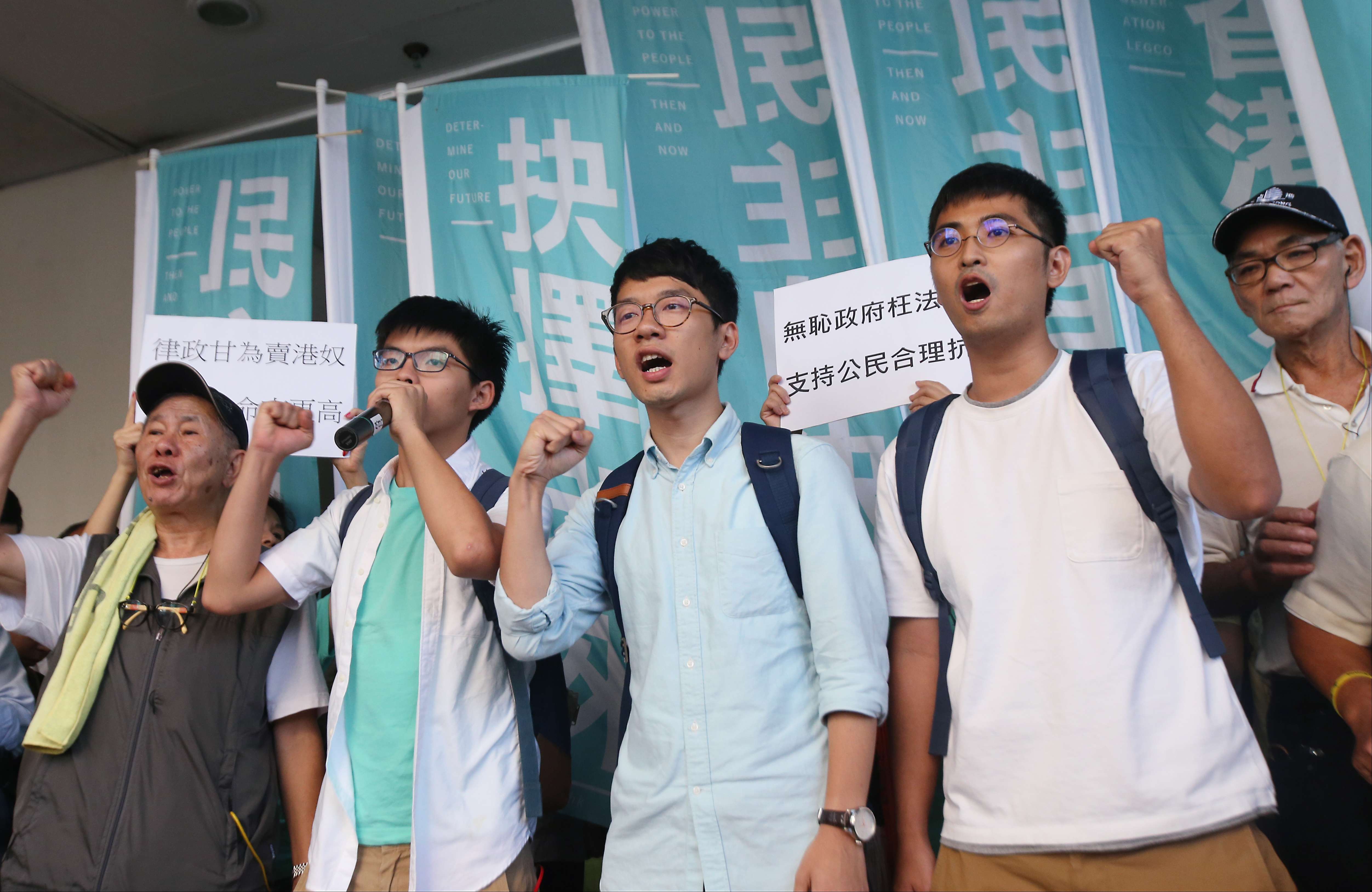 Umbrella movement leaders (from second left) Joshua Wong, Nathan Law and Alex Chow at Eastern Court in Sai Wan Ho last September. Hong Kong needs its youth to demonstrate a willingness and openness to embrace contrasting views in society. Photo: David Wong