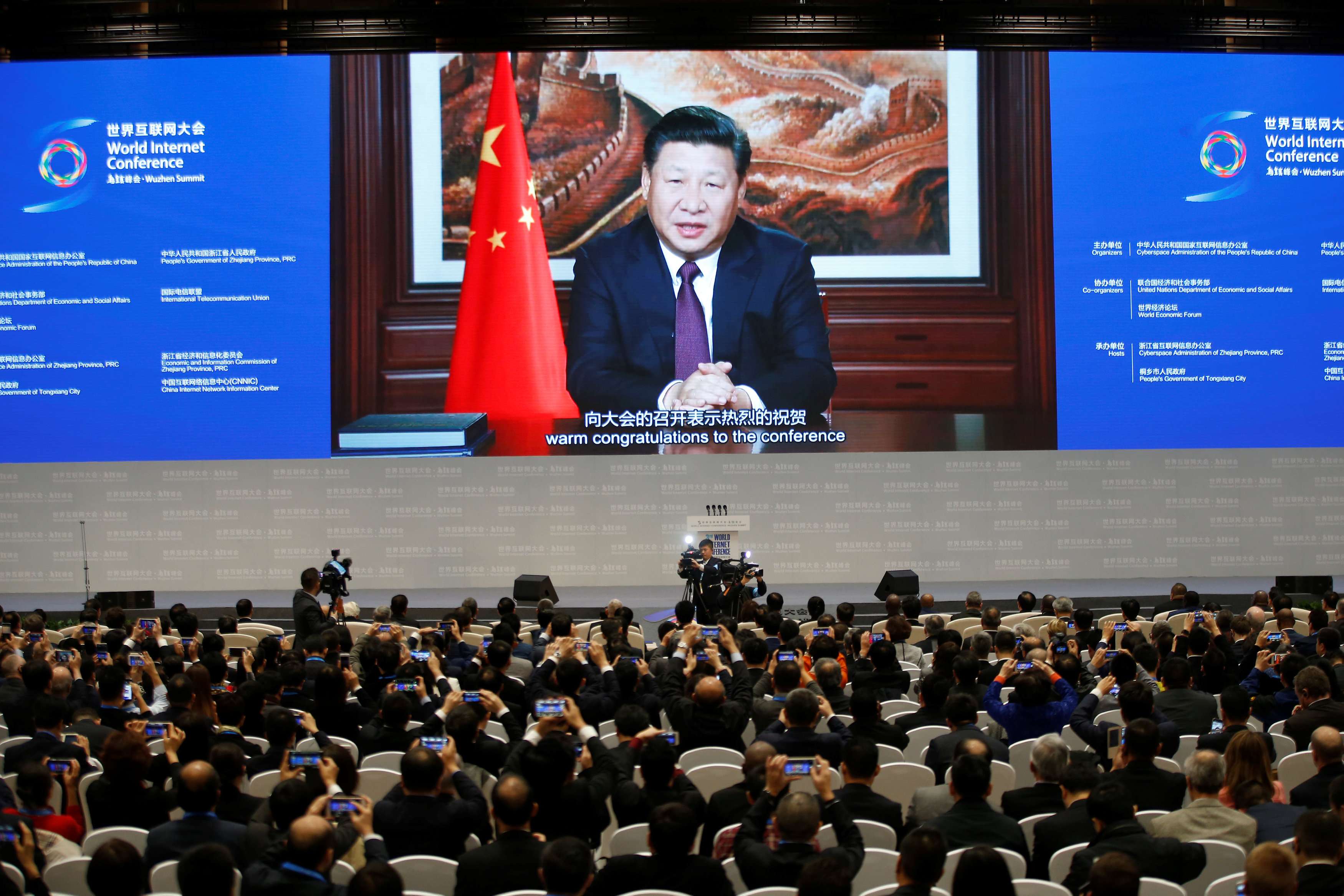 President Xi Jinping addresses the audience via video link during the opening ceremony of the third annual World Internet Conference in Wuzhen, Zhejiang province, last November 16. His presence at Davos is set to mark a consecration for China. Photo: Reuters