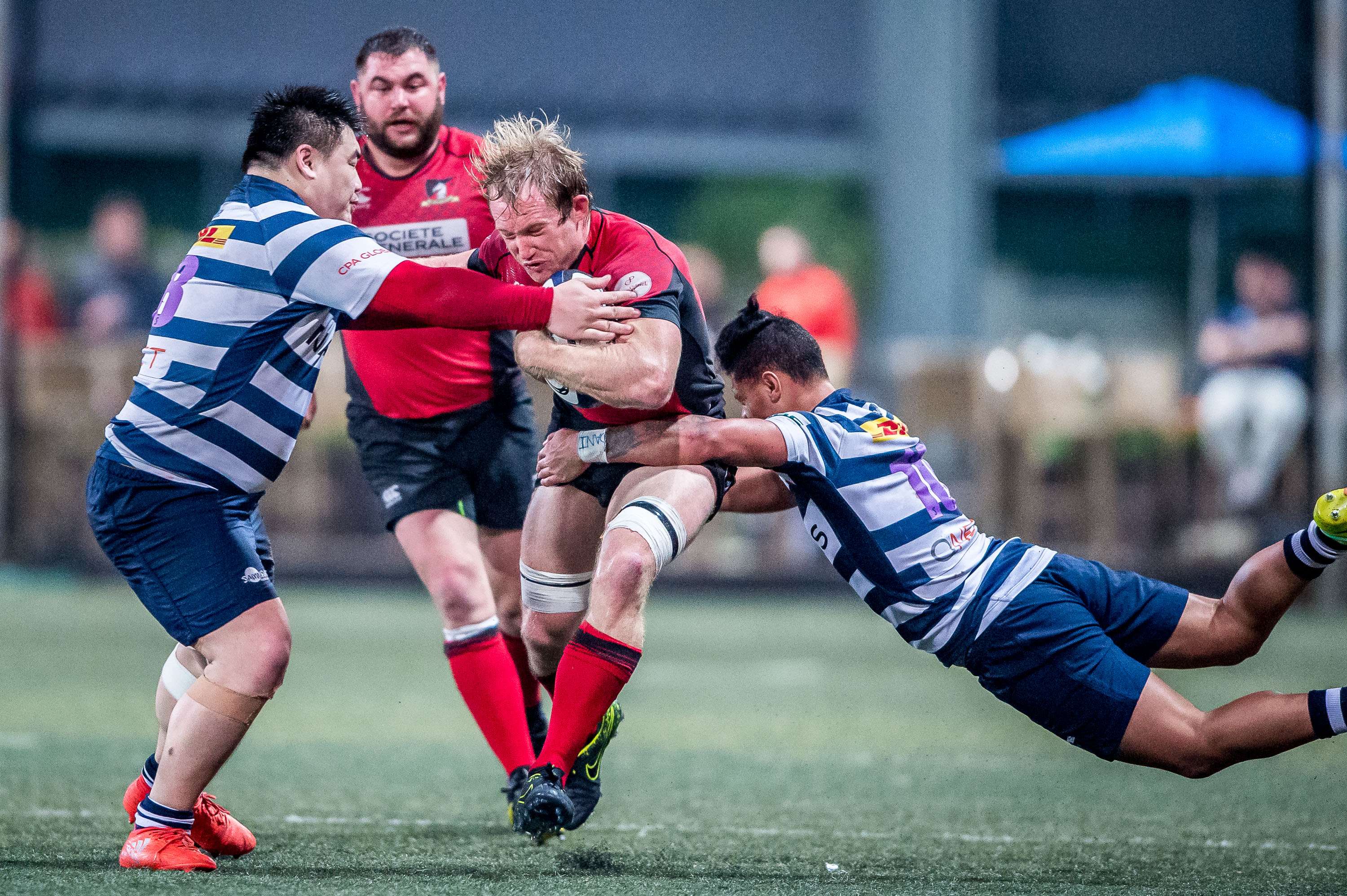 Toby Fenn takes on two HKFC tacklers during Valley’s impressive win in the Hong Kong Premiership on Saturday. Photos: HKRU