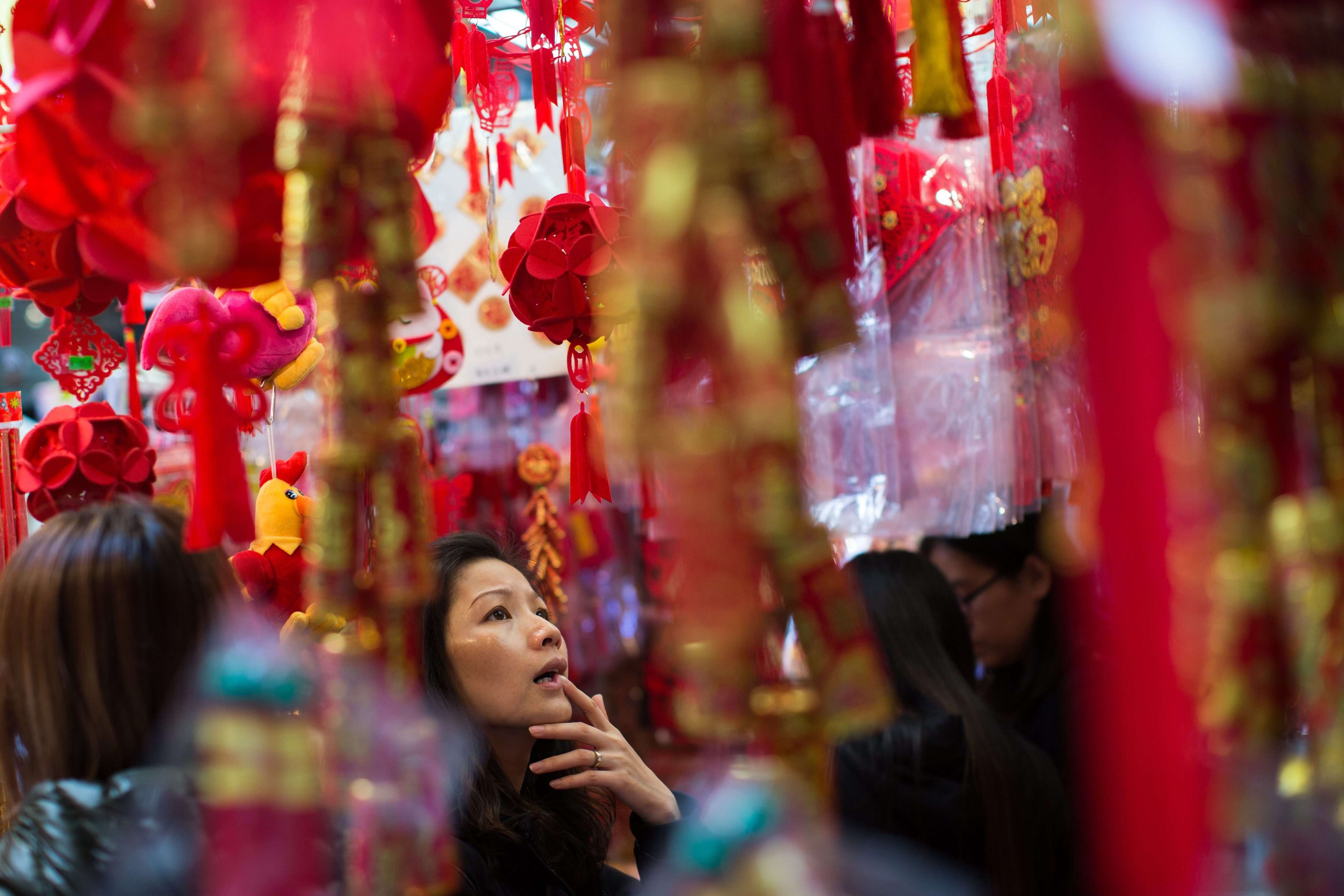 Hong Kong people prepare to celebrate the Lunar New Year. With US interest rates heading upwards, and mainland China rebalancing, the IMF expects only a gradual pick-up in Hong Kong’s growth rate, to 1.9 per cent in 2017. Photo: EPA