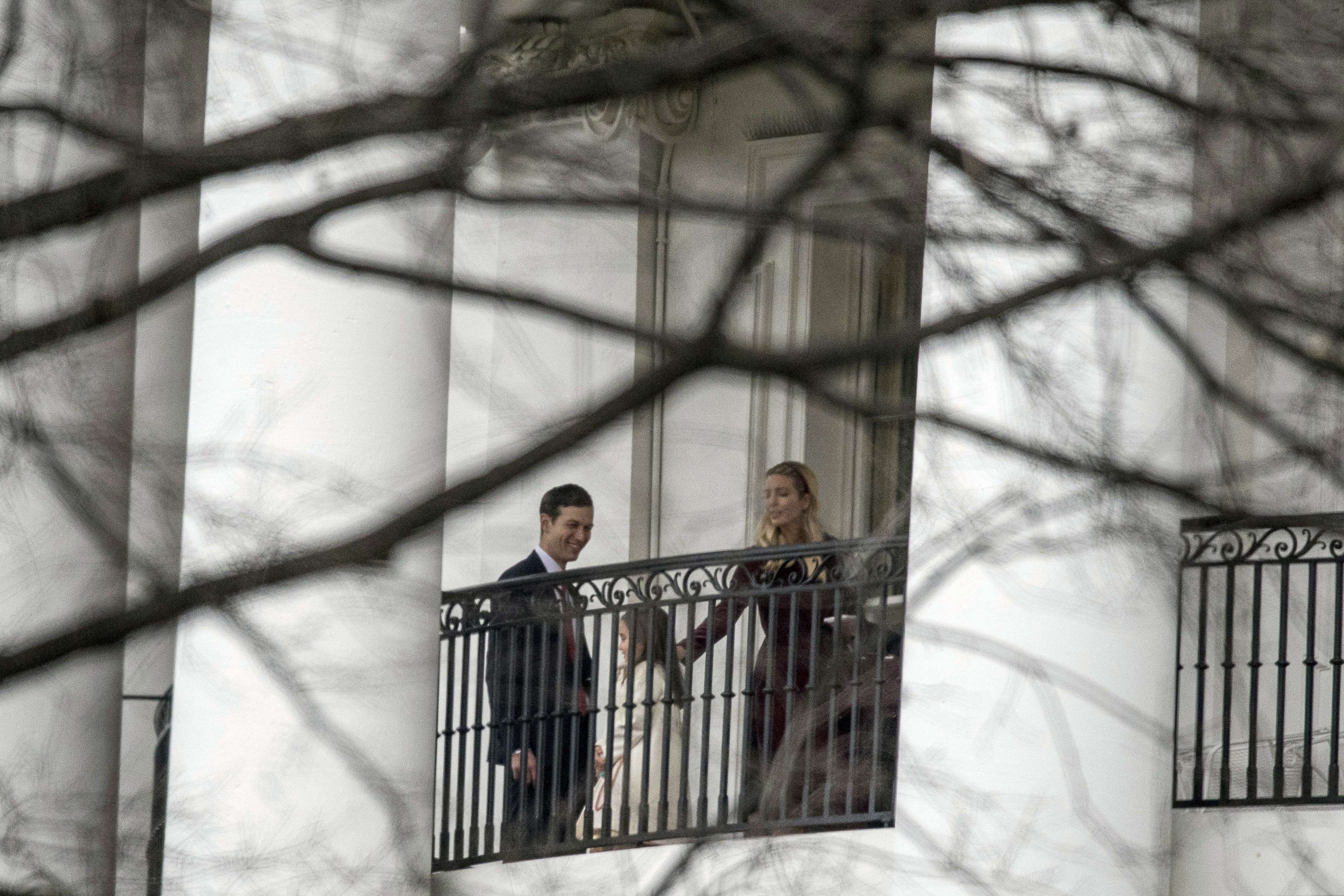 Ivanka Trump, the daughter of US President Donald Trump, right, her husband Jared Kushner, left, and their daughter Arabella Kushner, center, take photographs on the Truman Balcony of the White House on the first full day of Trump's administration. Photo: AP