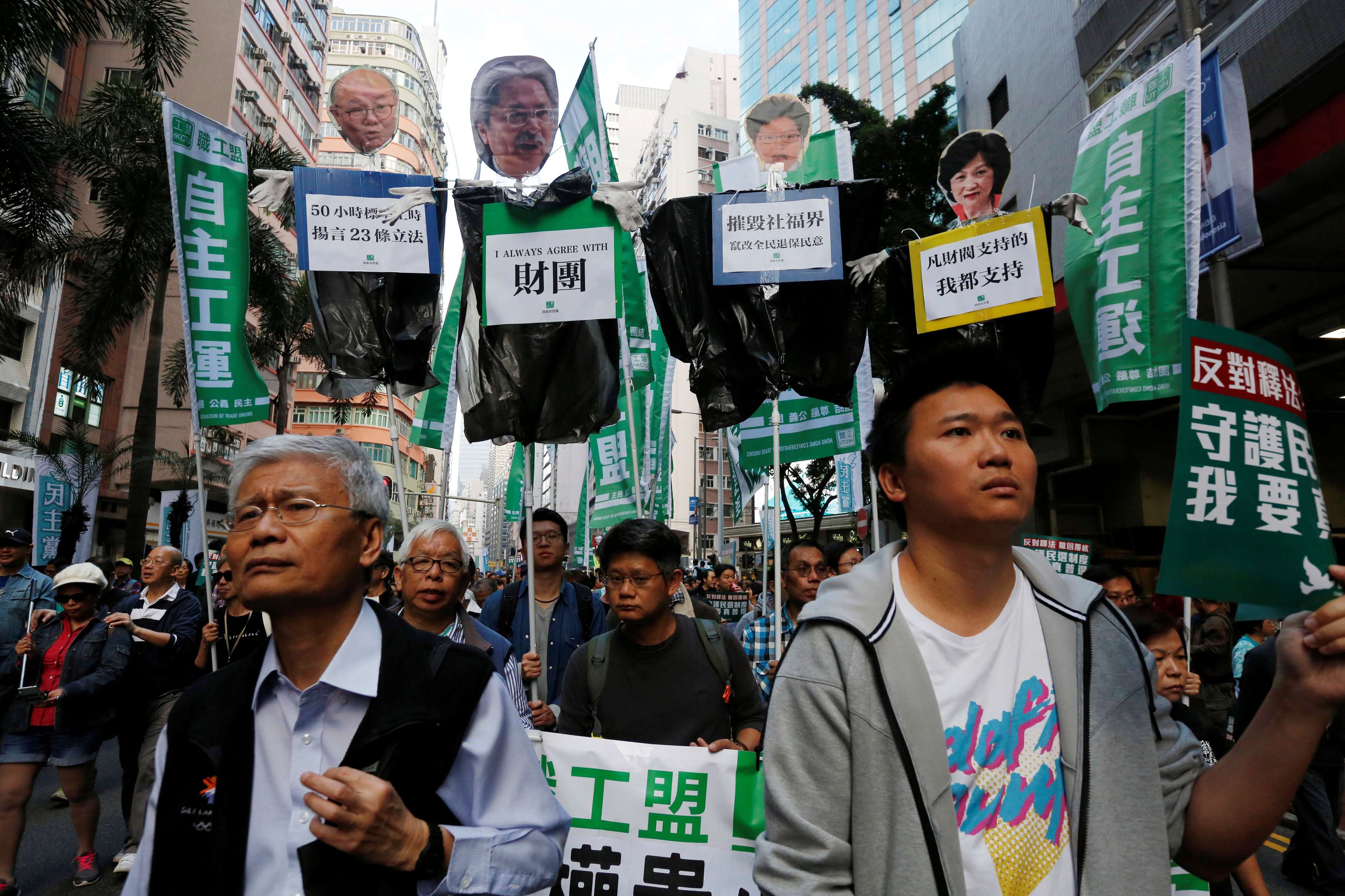 Protesters carry effigies of declared and then-potential chief executive candidates (from left) Woo Kwok-hing, John Tsang, Carrie Lam and Regina Ip, during a pro-democracy march in Hong Kong on January 1. Photo: Reuters