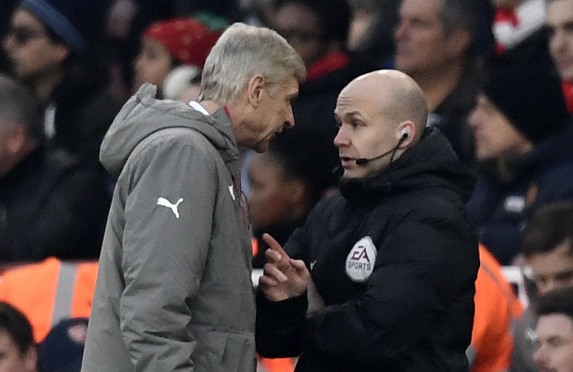 Arsenal manager Arsene Wenger clashes with fourth official Anthony Taylor before being sent to the stands. Photo: Reuters