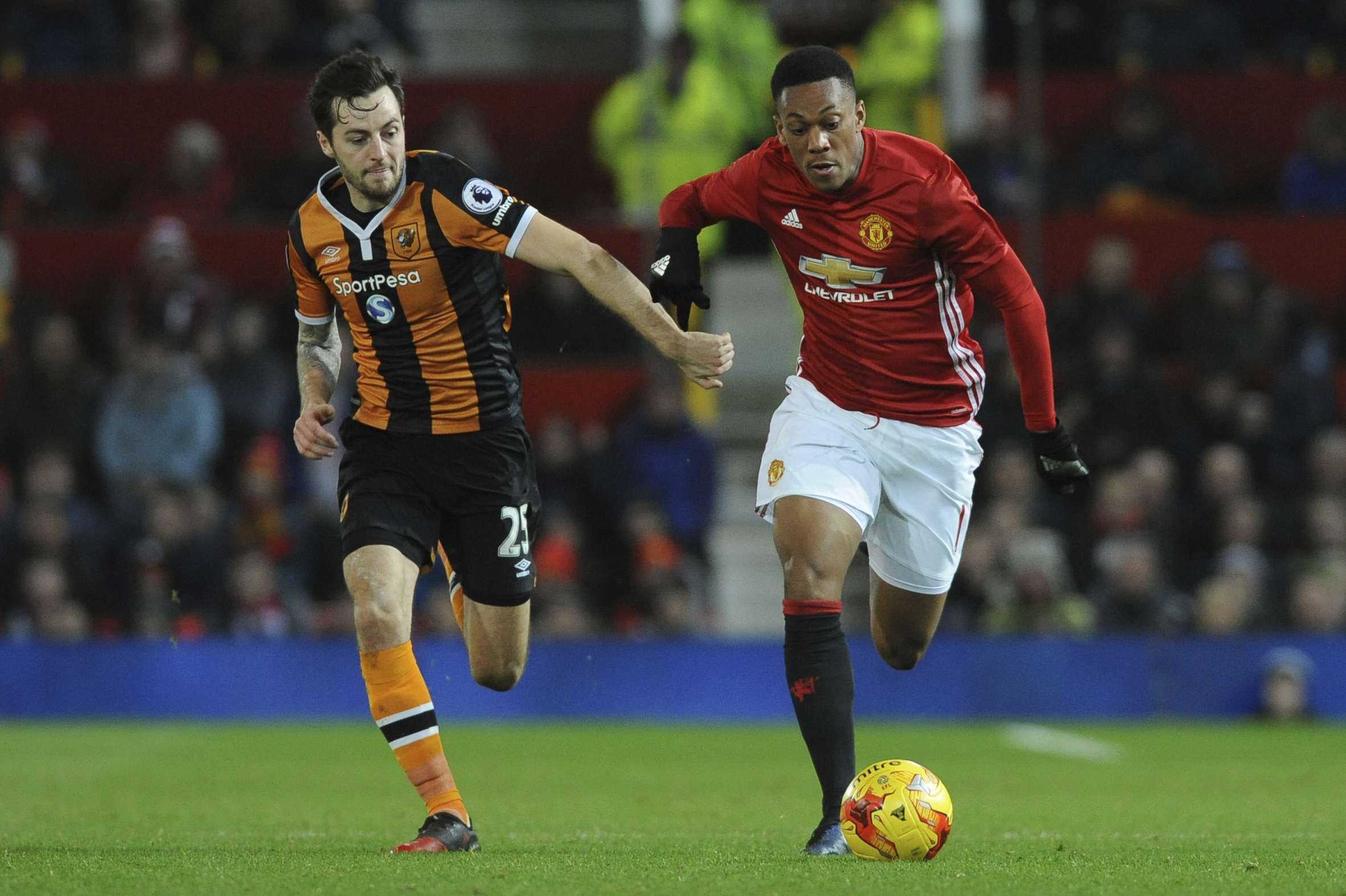 Anthony Martial holds off the challenge of Hull City's Ryan Mason. Photo: AP