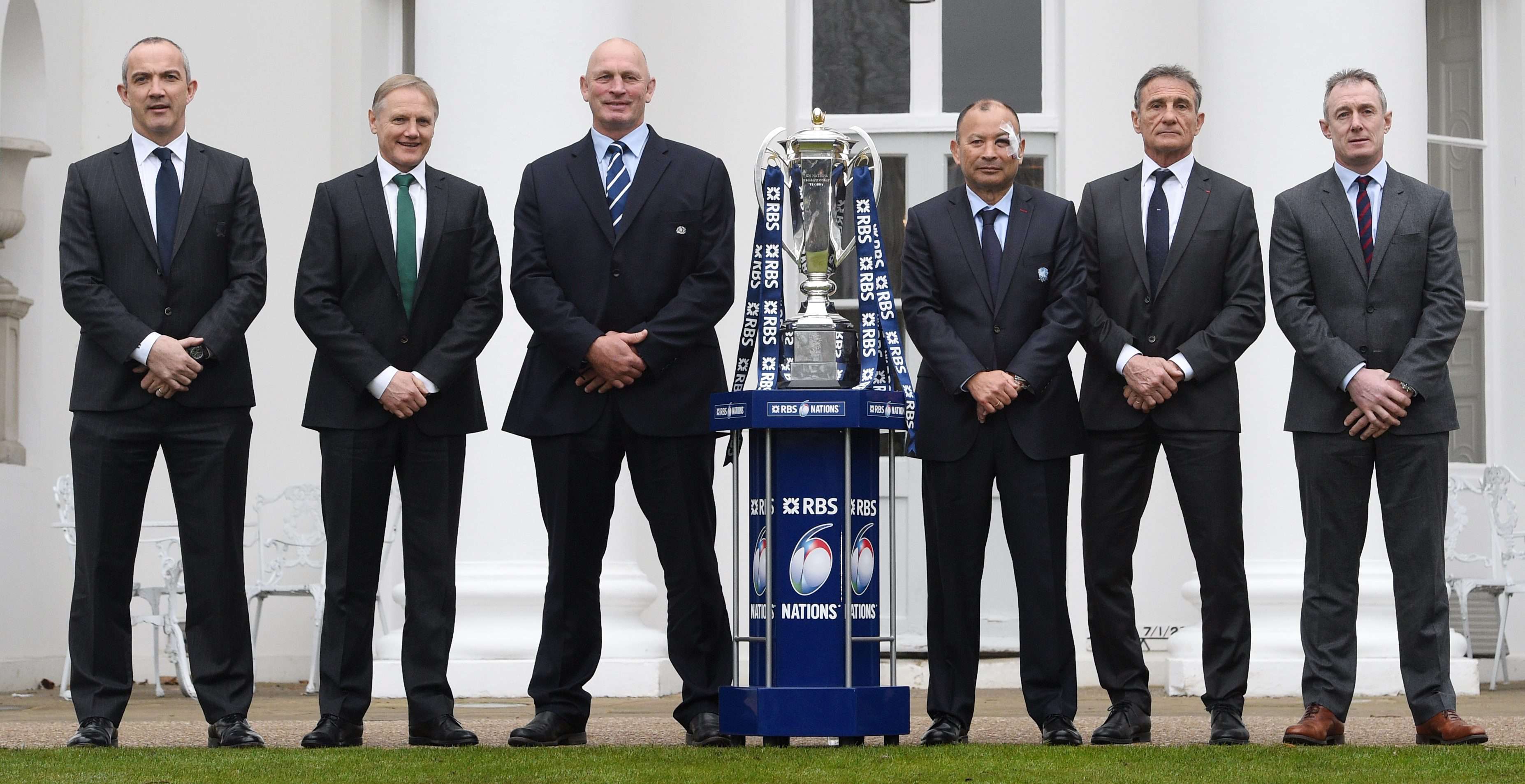 The head coaches of Italy, Ireland, Scotland, England, France and Wales pose with the Six Nations trophy. Photo: EPA