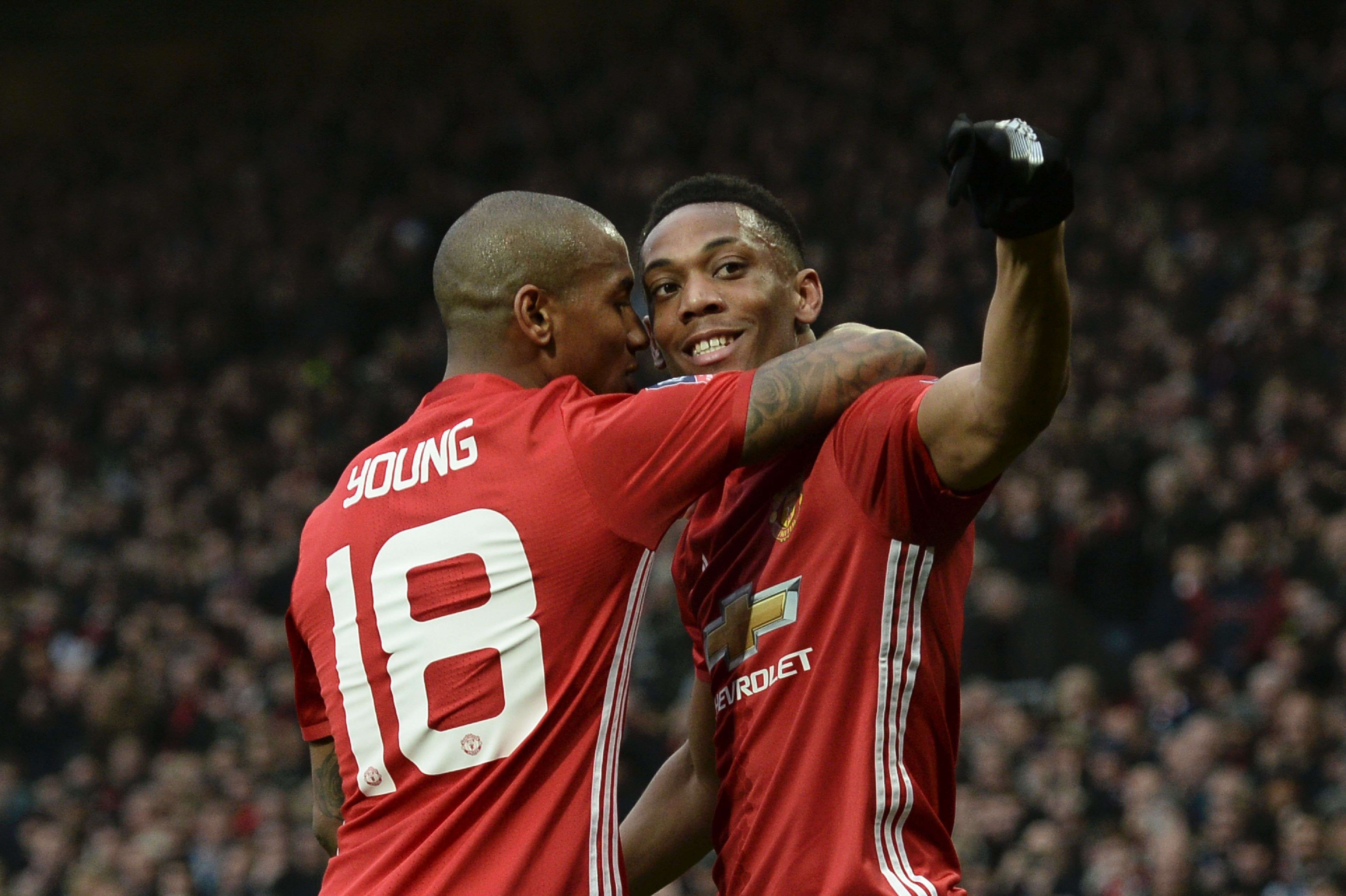 Manchester United's French striker Anthony Martial (right) celebrates with Ashley Young. Photo: AFP