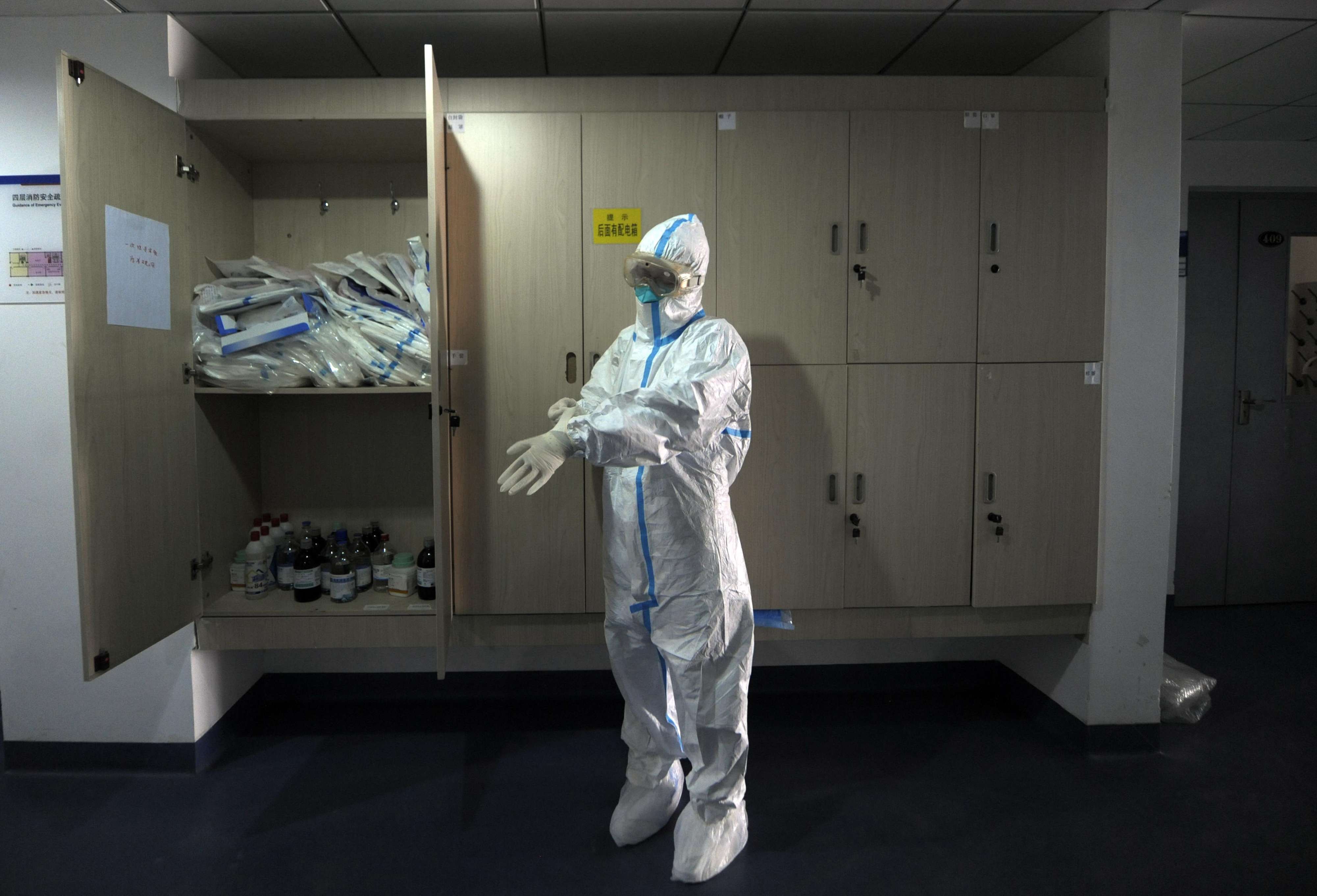 In this file photo from April 2013, a staff member with Beijing’s disease-control authority dons a protective suit. At least 130 cases of human infection have been reported across the Chinese mainland this year. Photo: AFP