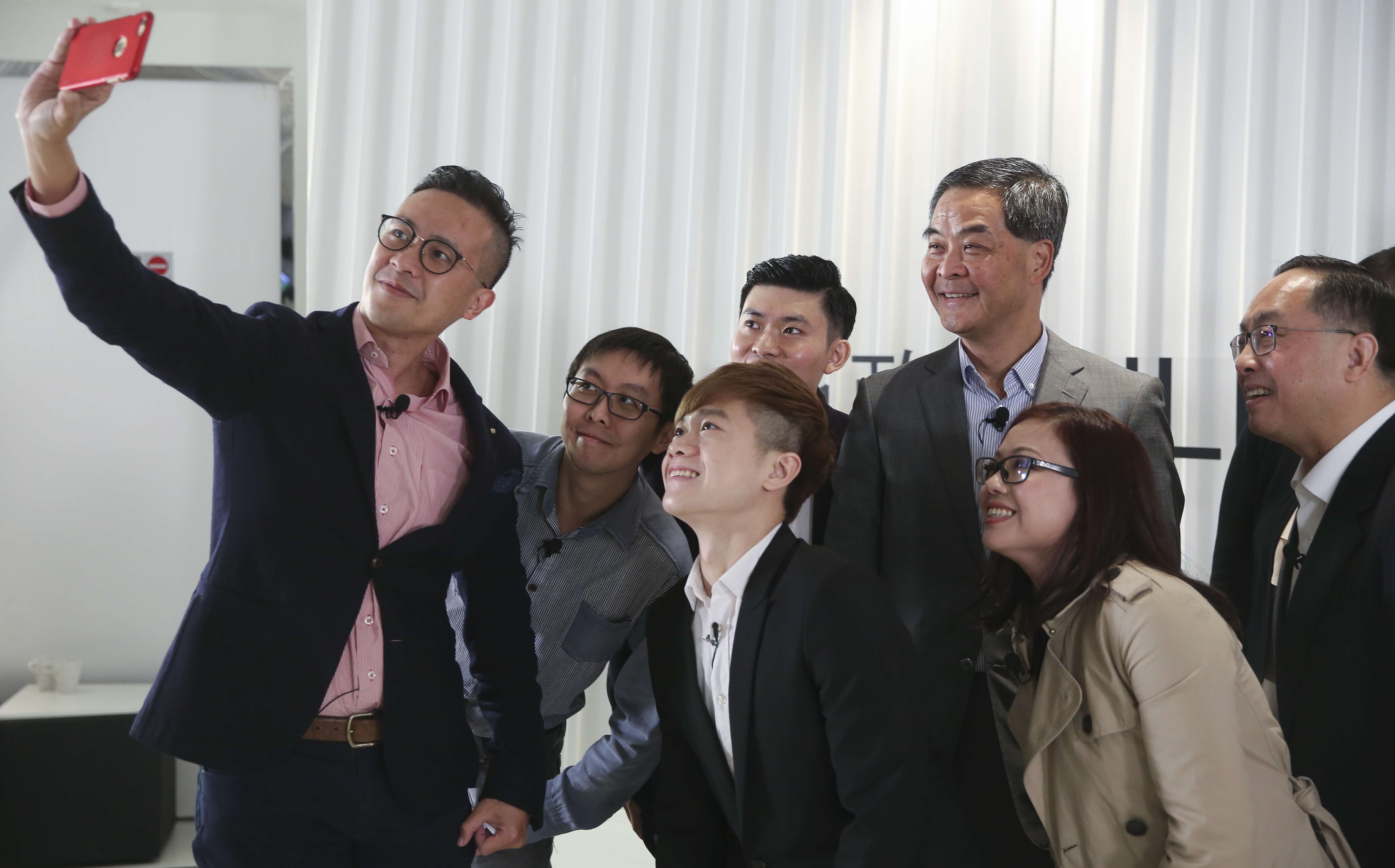 Young Hong Kong entrepreneurs take a group photo with Chief Executive Leung Chun-ying and Secretary for Innovation and Technology Nicholas Yang Wei-hsiung (right), during a Hong Kong Federation of Youth Groups web radio show at their Media 21 Media space in Aberdeen, on January 23. Photo: Sam Tsang