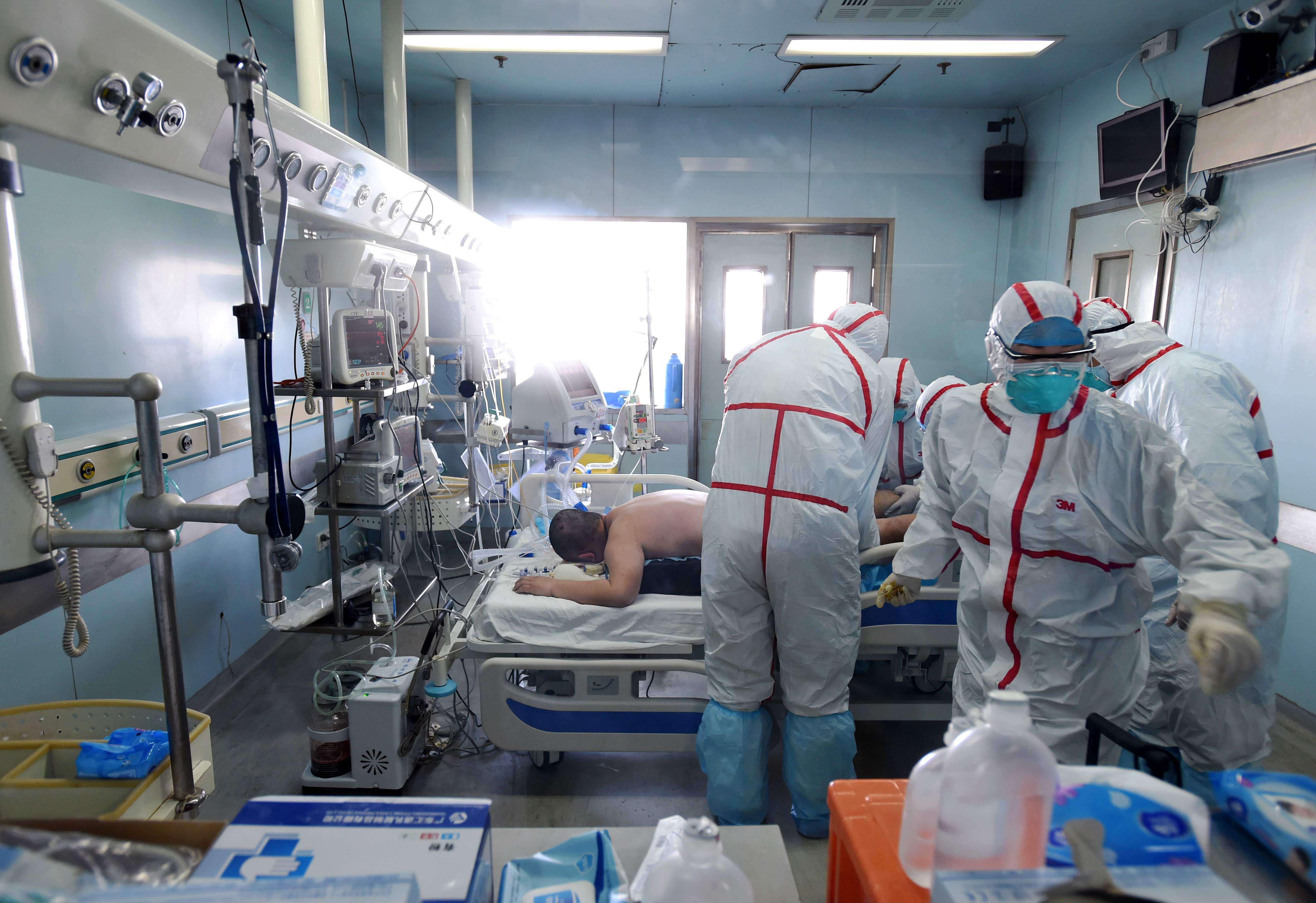 Medical workers in protective suits treat a patient with the H7N9 strain of bird flu at a hospital in Wuhan in Hubei province earlier this month. Photo: AFP