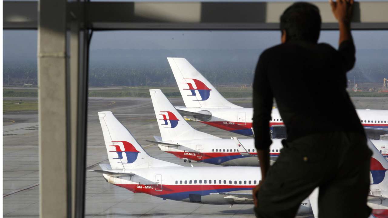 A traveller stands at the viewing gallery overlooking Malaysian Airline System (MAS) aircrafts at Kuala Lumpur International Airport in Sepang, one of the airports managed by Malaysia Airports Holdings Bhd . Photo: REUTERS/Bazuki Muhammad/Files