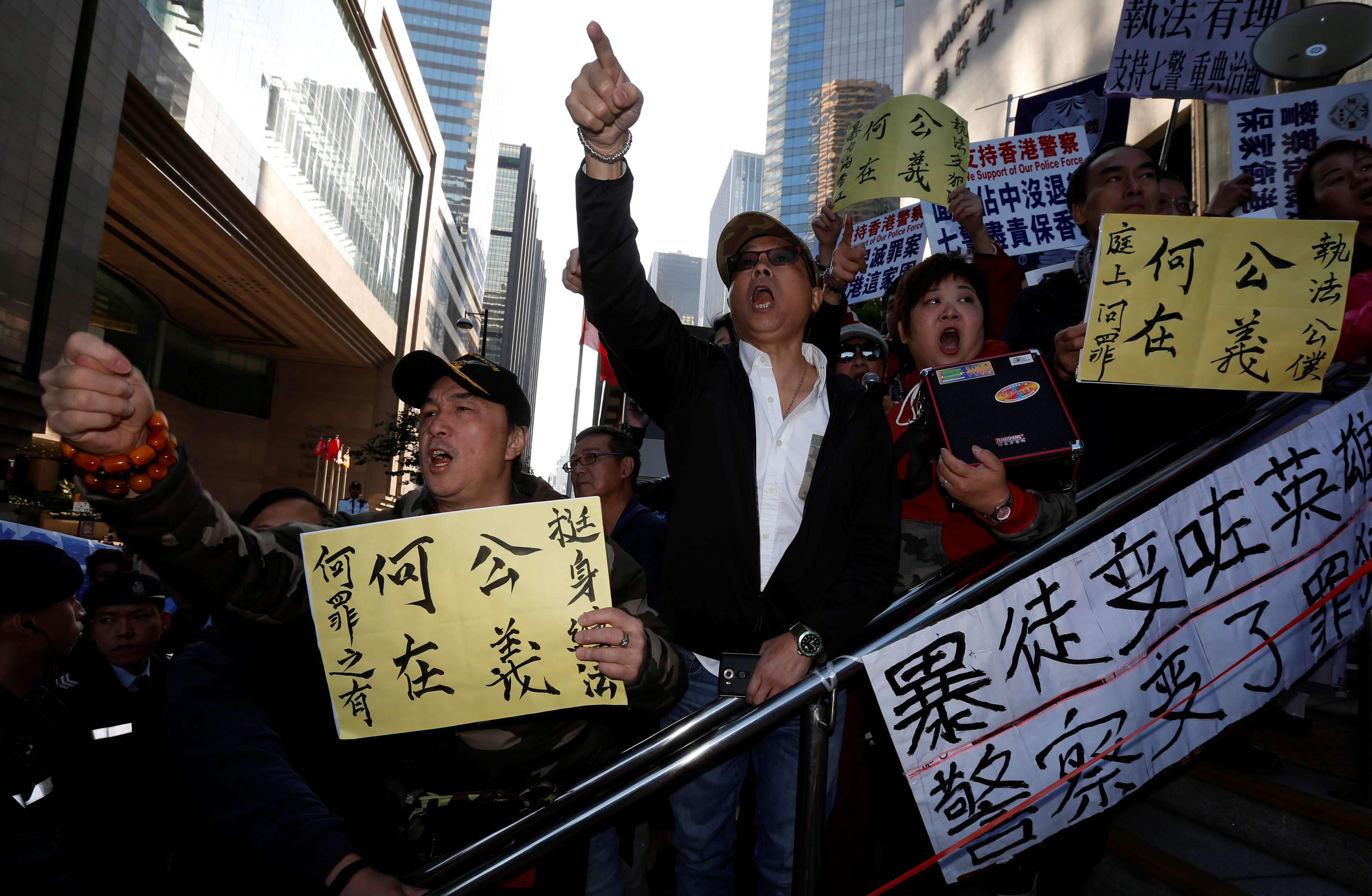 Supporters of police officers argue with pro-democracy protesters outside a court where seven police officers were convicted of kicking and punching activist Ken Tsang during an Occupy protest more than two years ago. Photo: Reuters