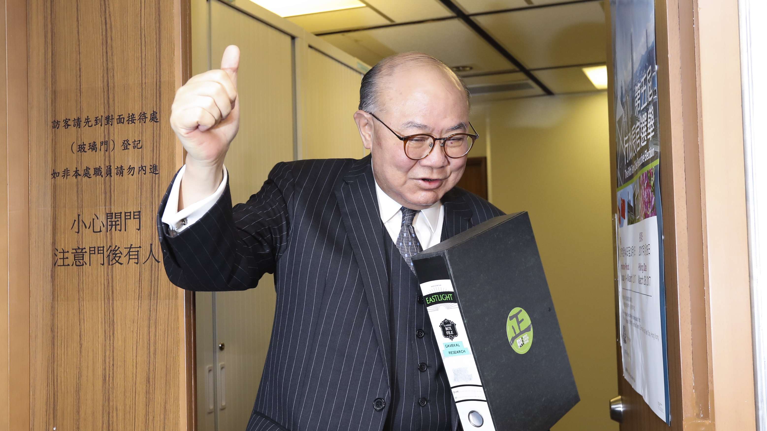 Woo Kwok-hing hands his nomination forms to election staff on Monday. Photo: Edward Wong