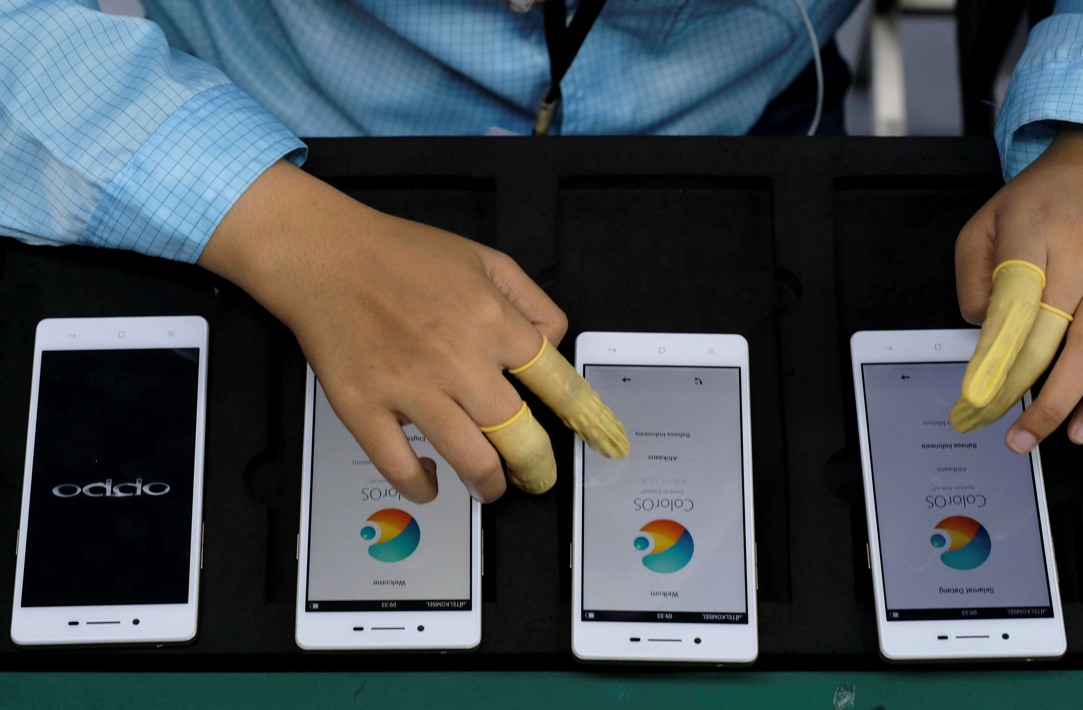 A worker tests Oppo smartphones at the company’s factory in Indonesia. Oppo said it has filed more than 50 patents for its new 5X dual camera zoom technology. Photo: Reuters