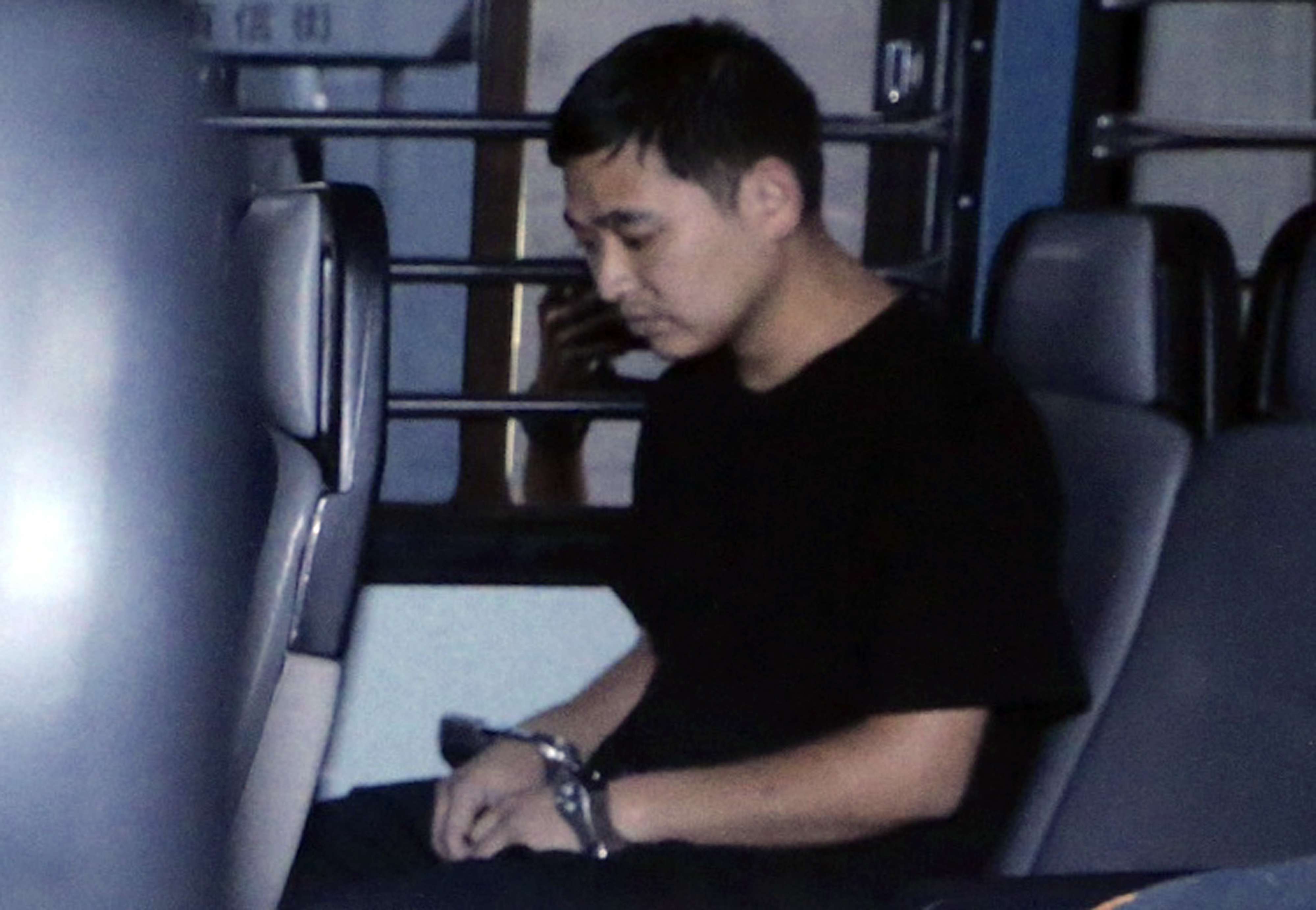 Zheng Xingwang is escorted away by Correctional Services Department staff after his second appearance in Kwun Tong Court in May 2015. Photo: David Wong