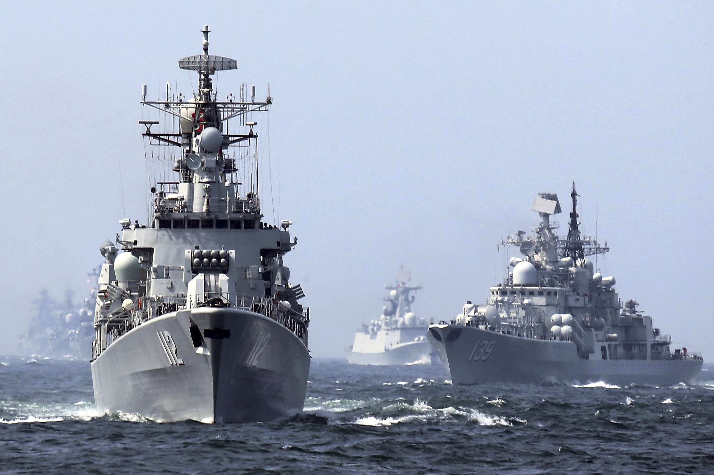 In this May 24, 2014, file photo, China's Harbin (112) guided missile destroyer and DDG-139 Ningbo Sovremenny class Type-956EM destroyer, right, take part in a week-long China-Russia "Joint Sea-2014" navy exercise at the East China Sea off Shanghai, China. A Chinese navy task force wrapped up visits to four Persian Gulf states as the increasingly capable maritime force grows its presence in the strategically vital region. The three ships, including Harbin, departed Kuwait on Sunday, Feb. 5, 2017, after stopping in Saudi Arabia, Qatar and the United Arab Emirates, the Defense Ministry said on its website Monday, Feb. 6, 2017. (Chinatopix via AP)