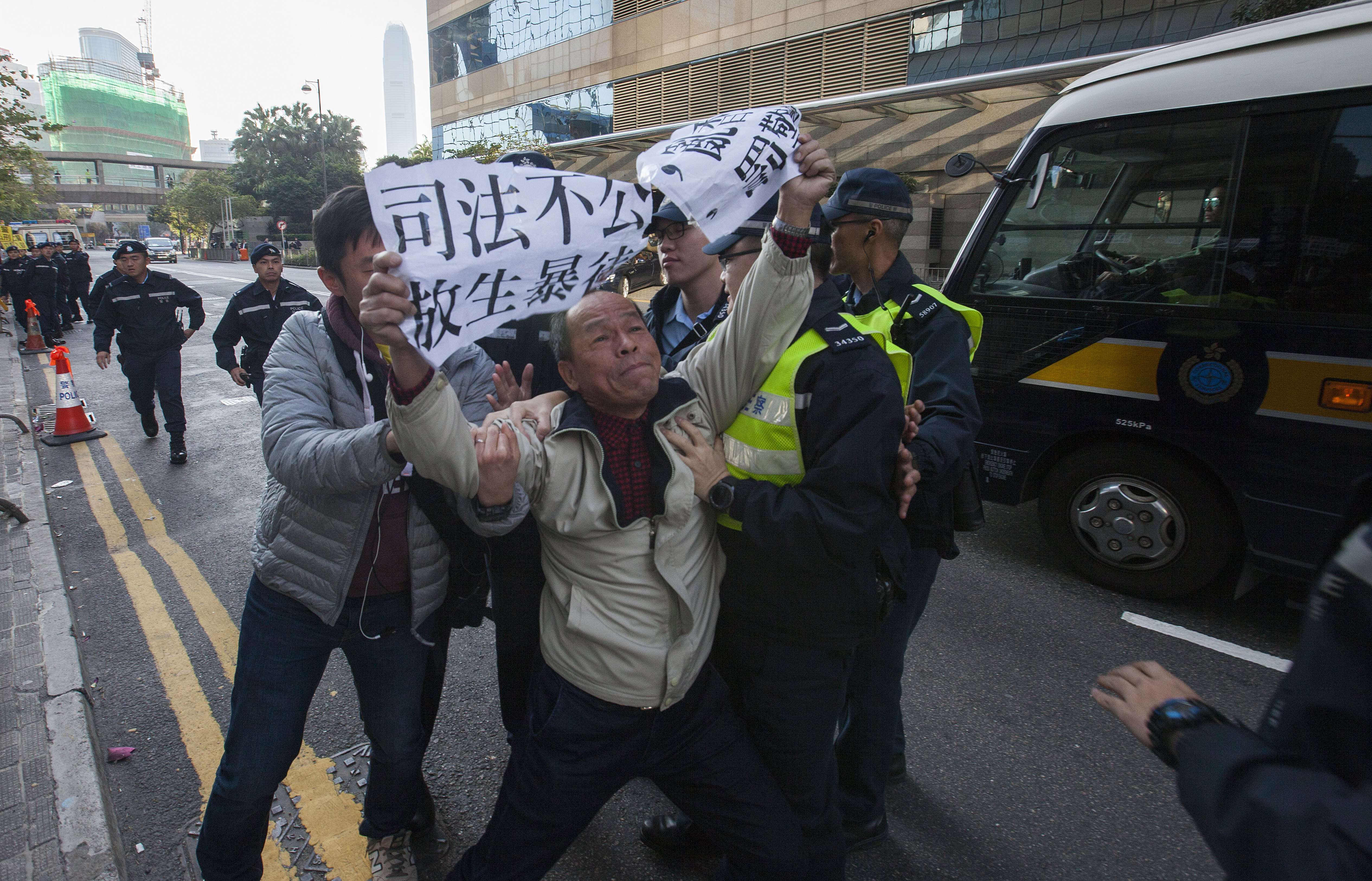 A protester objects to the conviction of the seven police officers for assaulting an Occupy protester. Photo: EPA