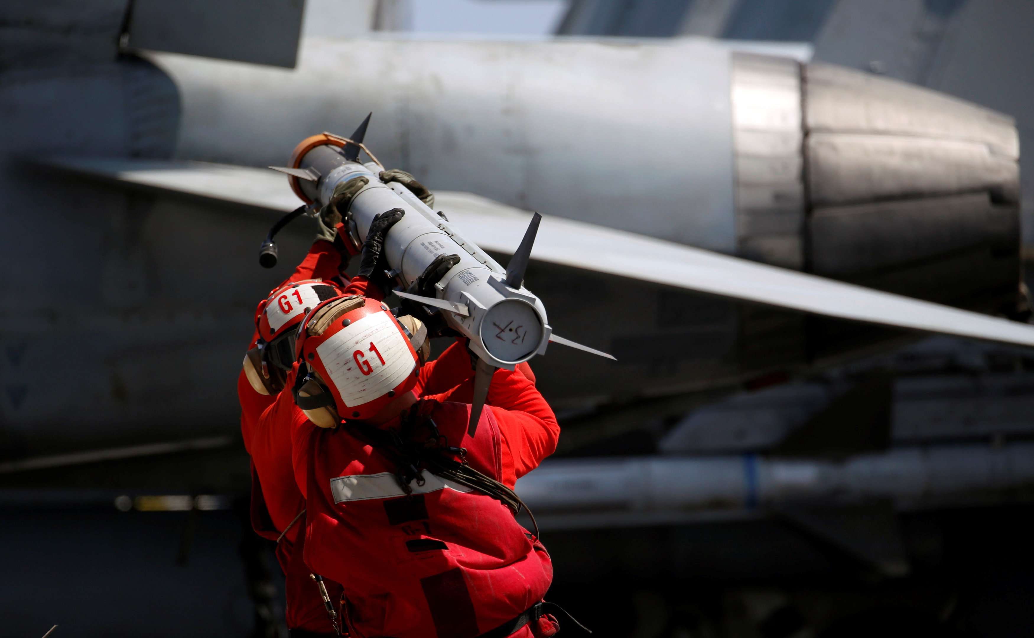 US Navy personnel carry a missile to arm an F-18 fighter jet on the deck of the USS Carl Vinson during a routine exercise in the South China Sea earlier this month. Photo: Reuters