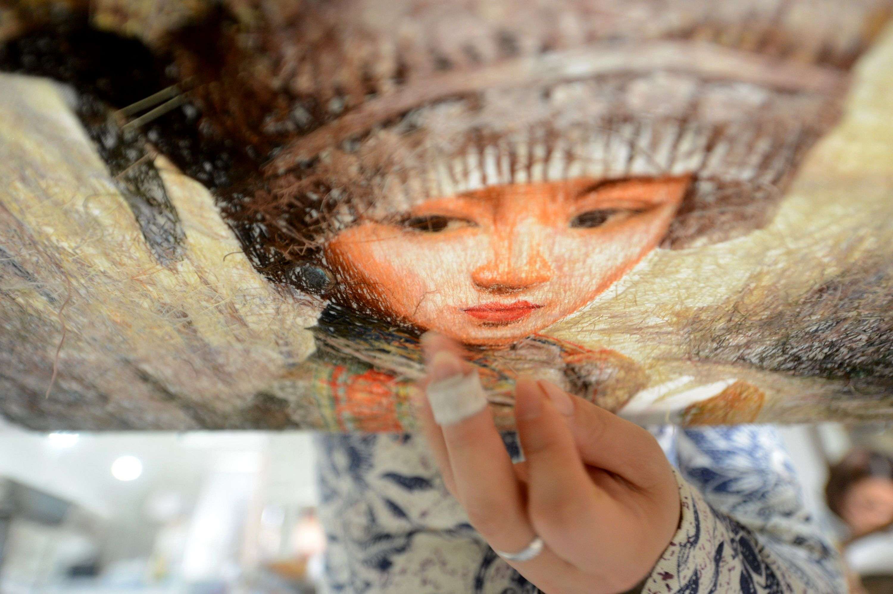 A woman in Yangzhou, Jiangsu province, works on an embroidery this week to mark International Women’s Day on Wednesday. The real issue of leftover women isn’t one of tradition or even nagging, overbearing parents. Photo: AFP