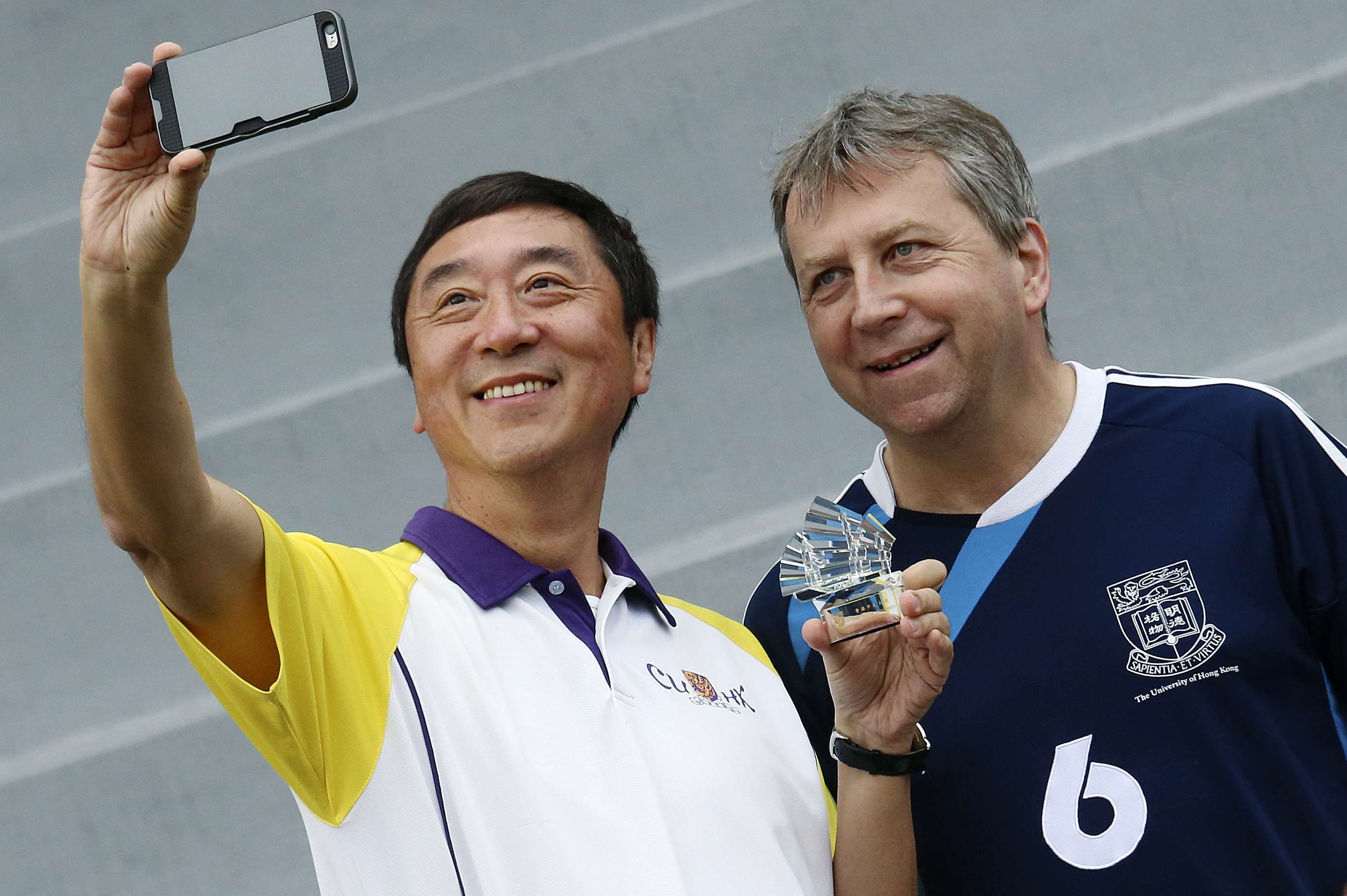 Joseph Sung (left) and Peter Mathieson attend the annual soccer match. Chinese University beat the University of Hong Kong 2-0. Photo: David Wong