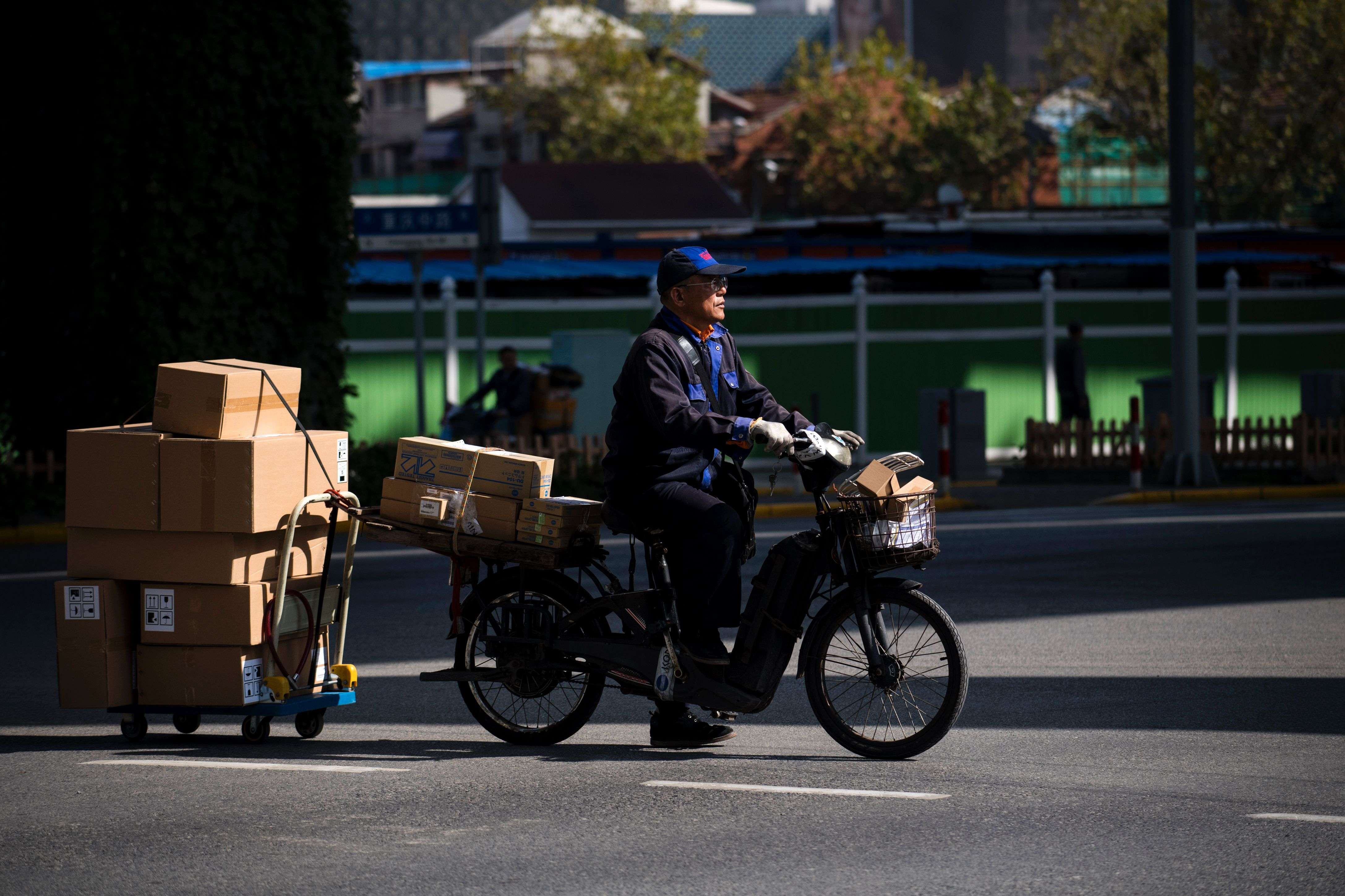 A man delivers parcels ordered online in Shanghai. Photo: AFP