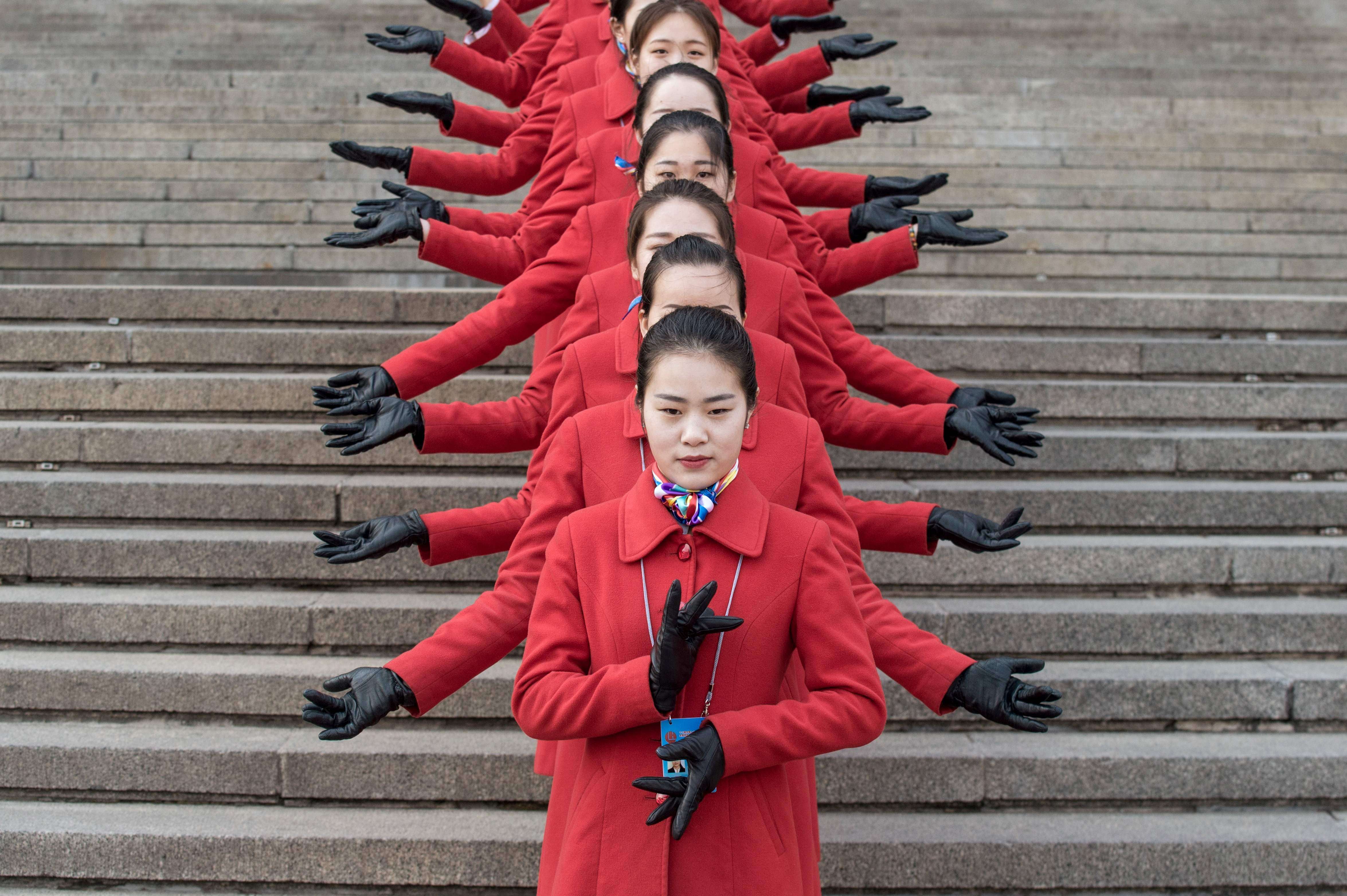 Hostesses pose during the opening session of the Chinese People's Political Consultative Conference (CPPCC) in the Great Hall of the People in Beijing. Photo: AFP