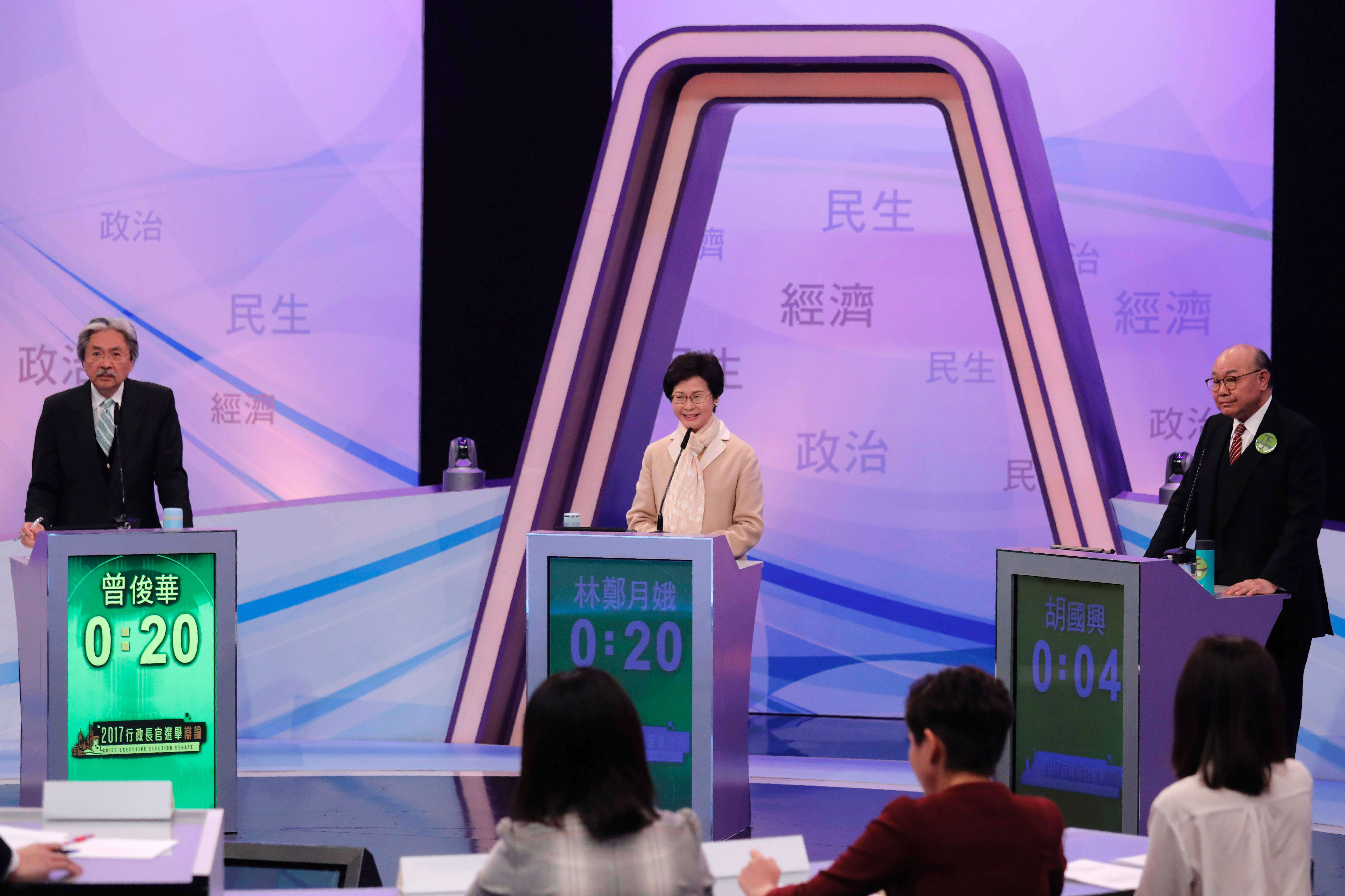 Hong Kong's three leadership candidates (L-R) John Tsang, Carrie Lam, and ex-judge Woo Kwok-hing attend the first televised debate at the TVB studio. Photo: AFP