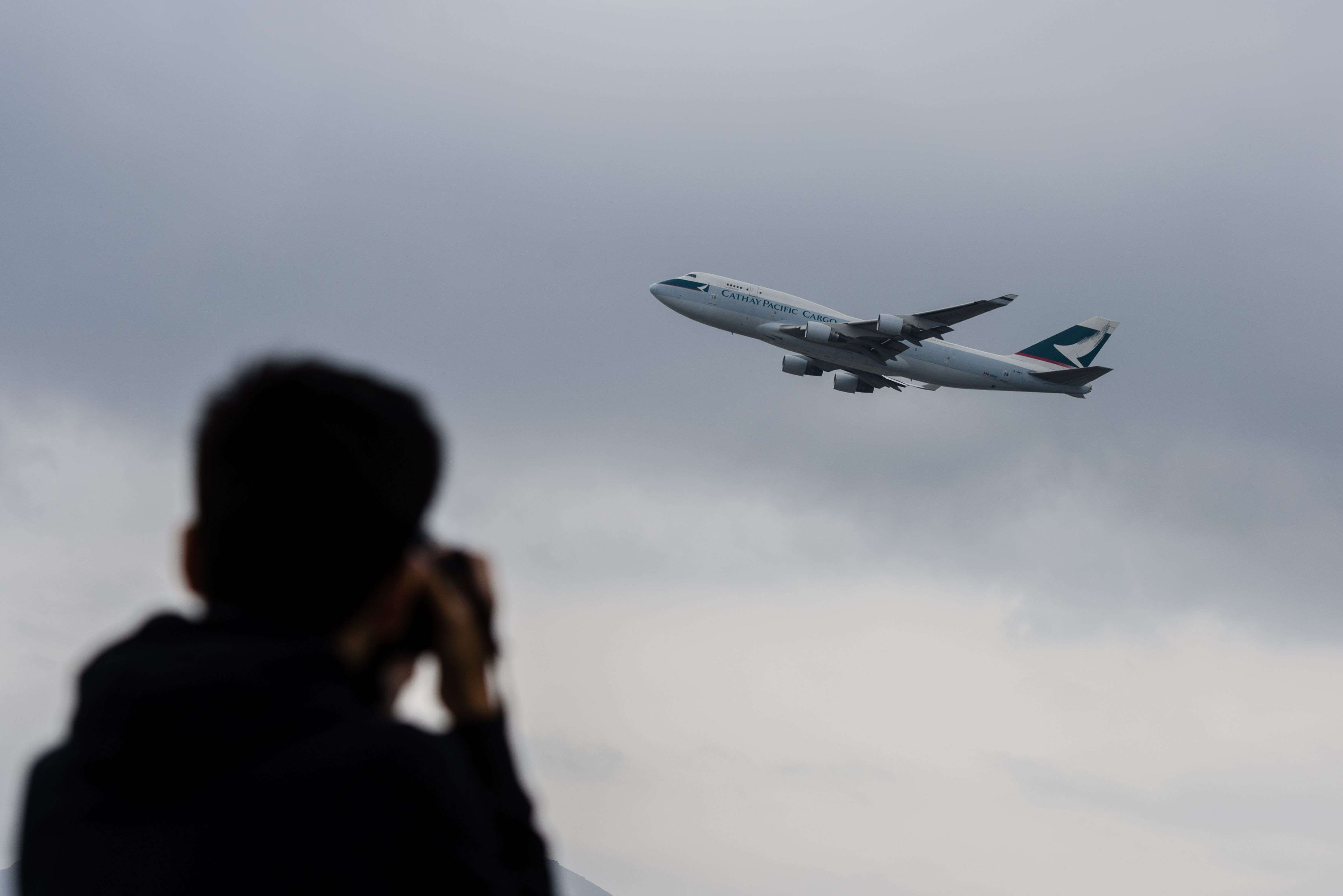 An aviation enthusiast photographs a Cathay Pacific cargo plane as it takes off from the international airport in Hong Kong this month. Symbolically, Cathay is to Hong Kong’s autonomy in the air what the territory’s political and economic institutions are to its special status on the ground. Photo: AFP
