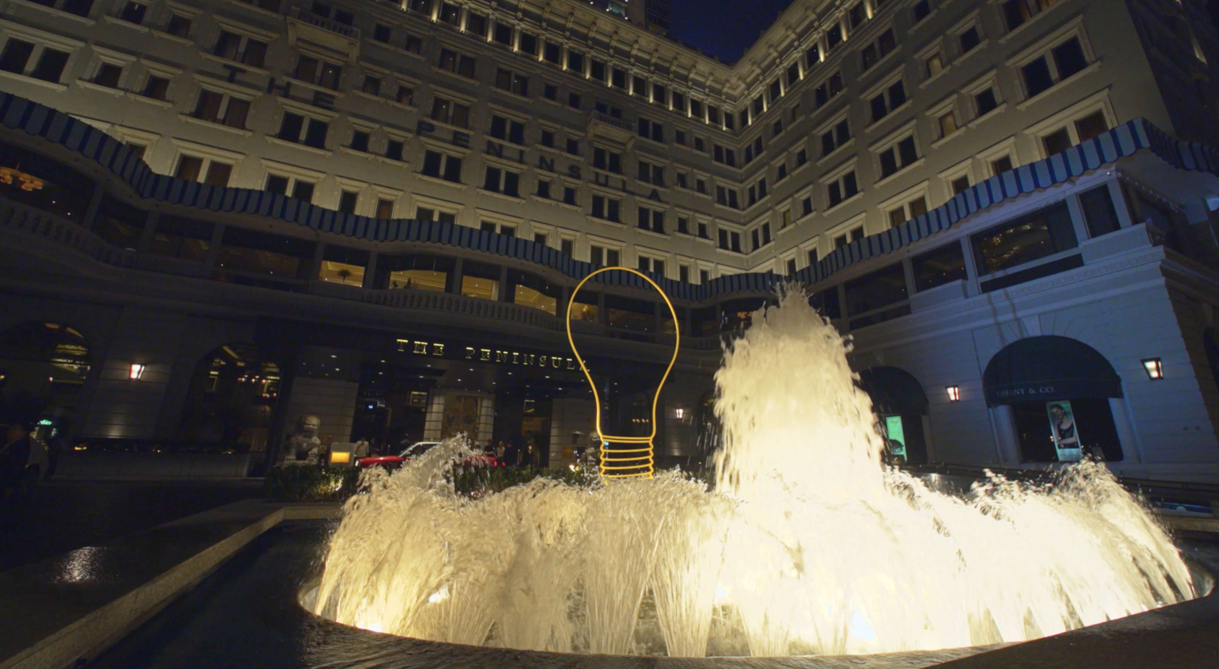 Bright Idea 2016, a giant light bulb in steel, appears to float atop The Peninsula hotel’s fountain. Photo: courtesy of The Peninsula