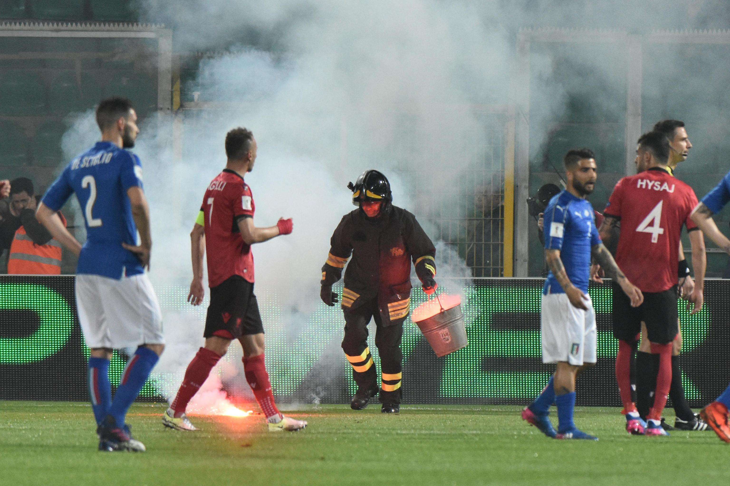 A fireman tries to clear the pitch. Photo: EPA