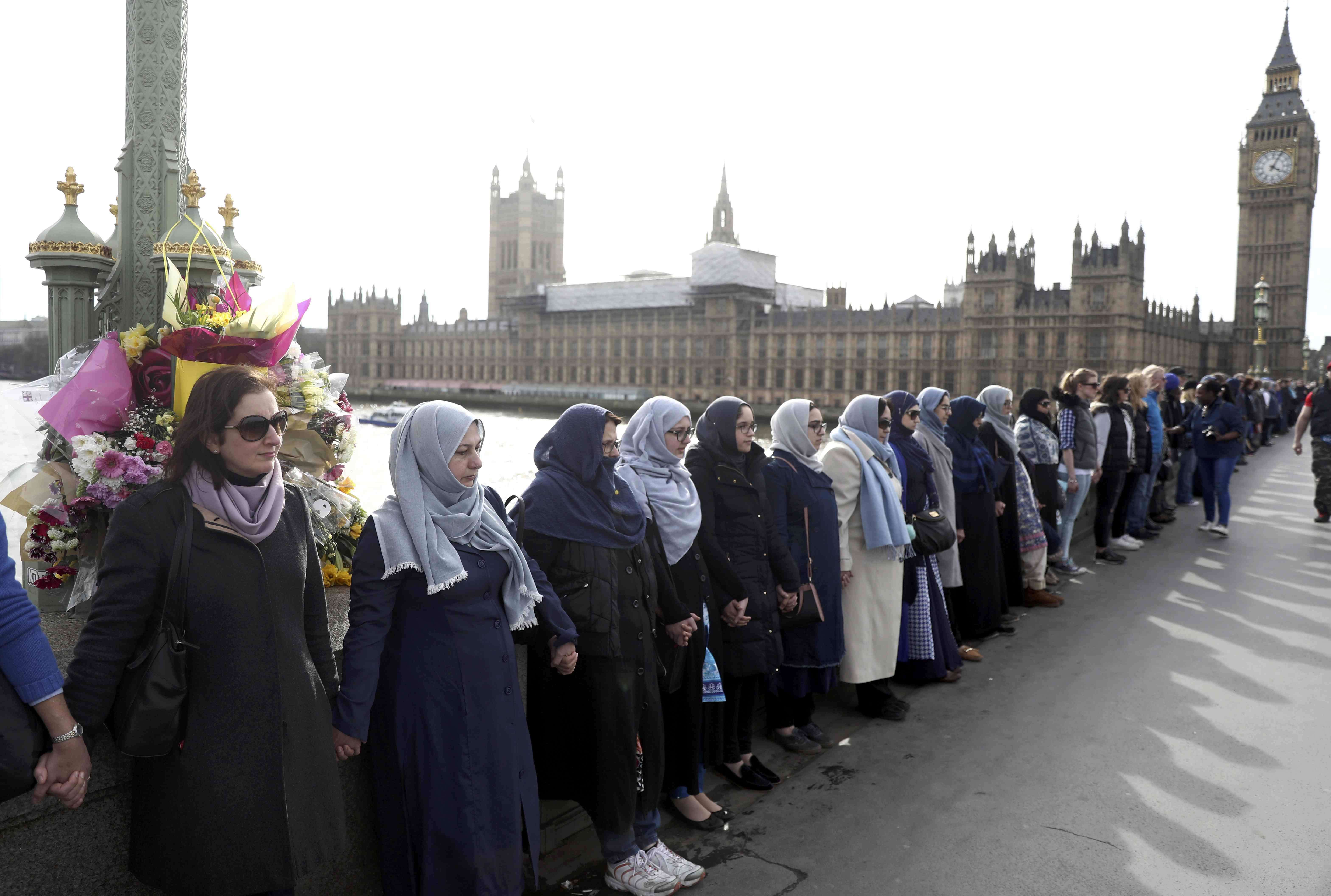 Participants in the Women's March, gather on Westminster Bridge to hold hands in silence, to remember victims of the attack in Westminster earlier in the week, in London on Sunday. Photo: Reuters