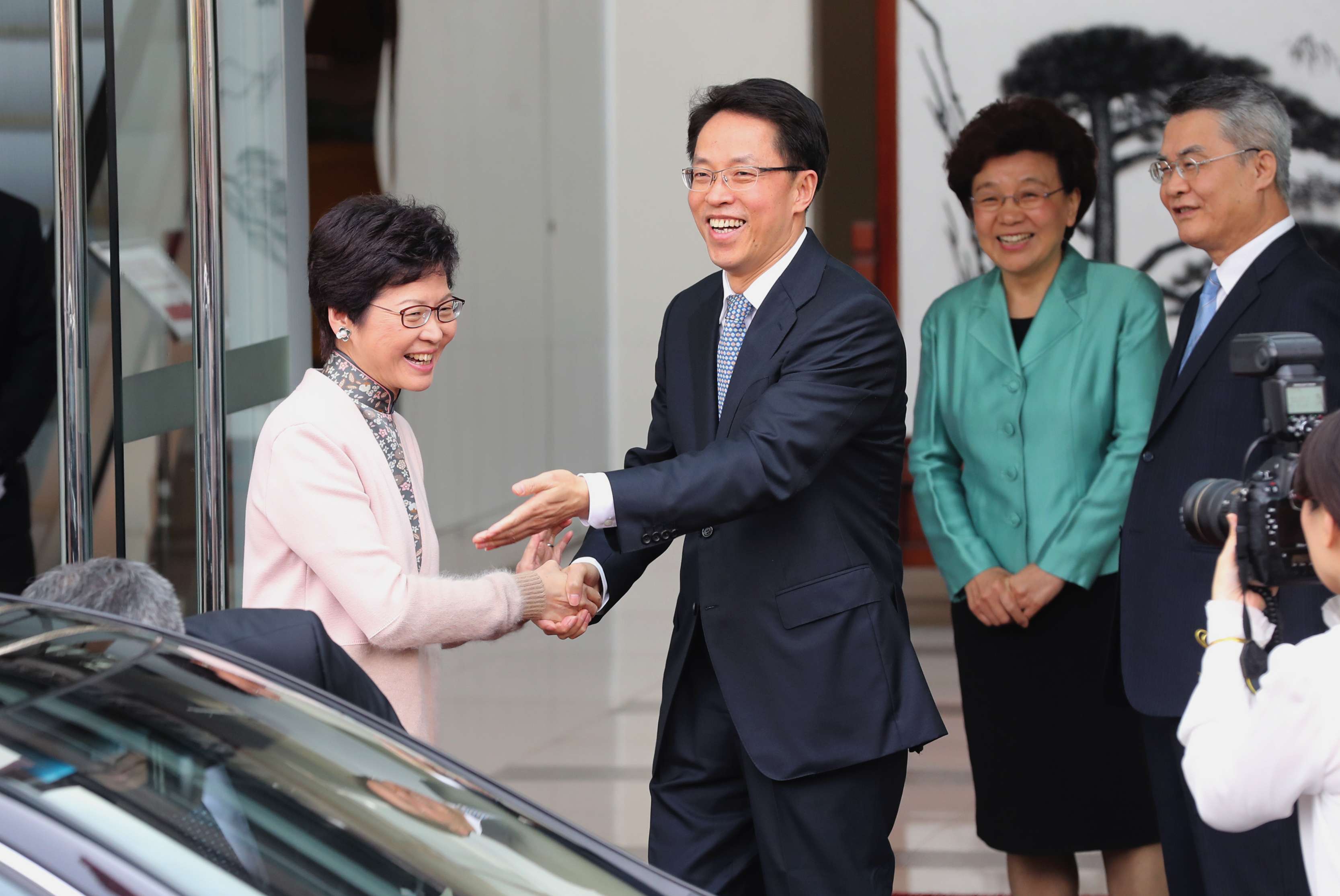 Carrie Lam is greeted by liaison office director Zhang Xiaoming. Photo: Edward Wong