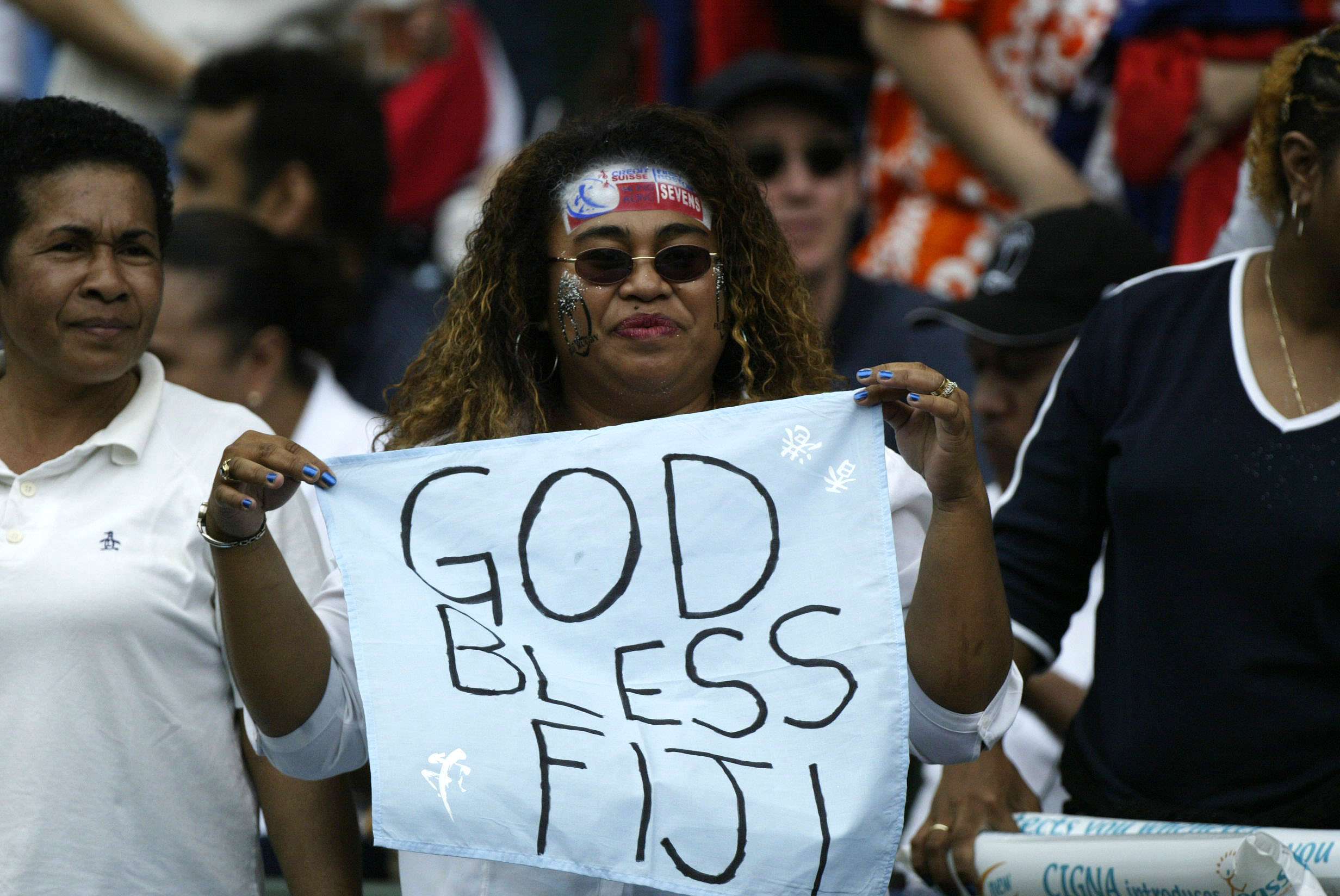 A Fijian rugby fan cheers for her favourite team during the Hong Kong Rugby Sevens tournament at Hong Kong Stadium. 30 March 2003
