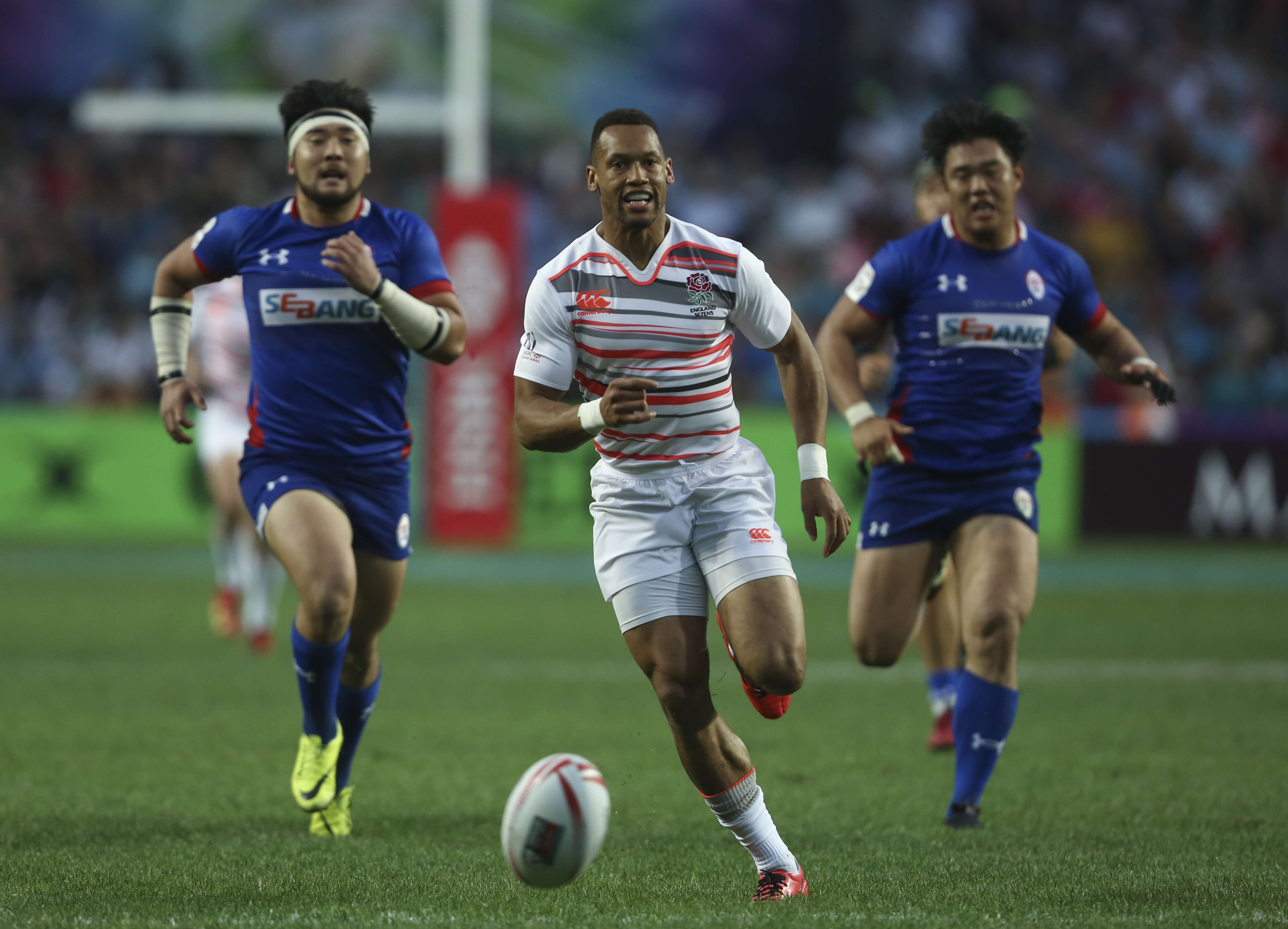 Dan Norton (centre) of England chases the ball during the record-setting win over South Korea. Photo: Jonathan Wong