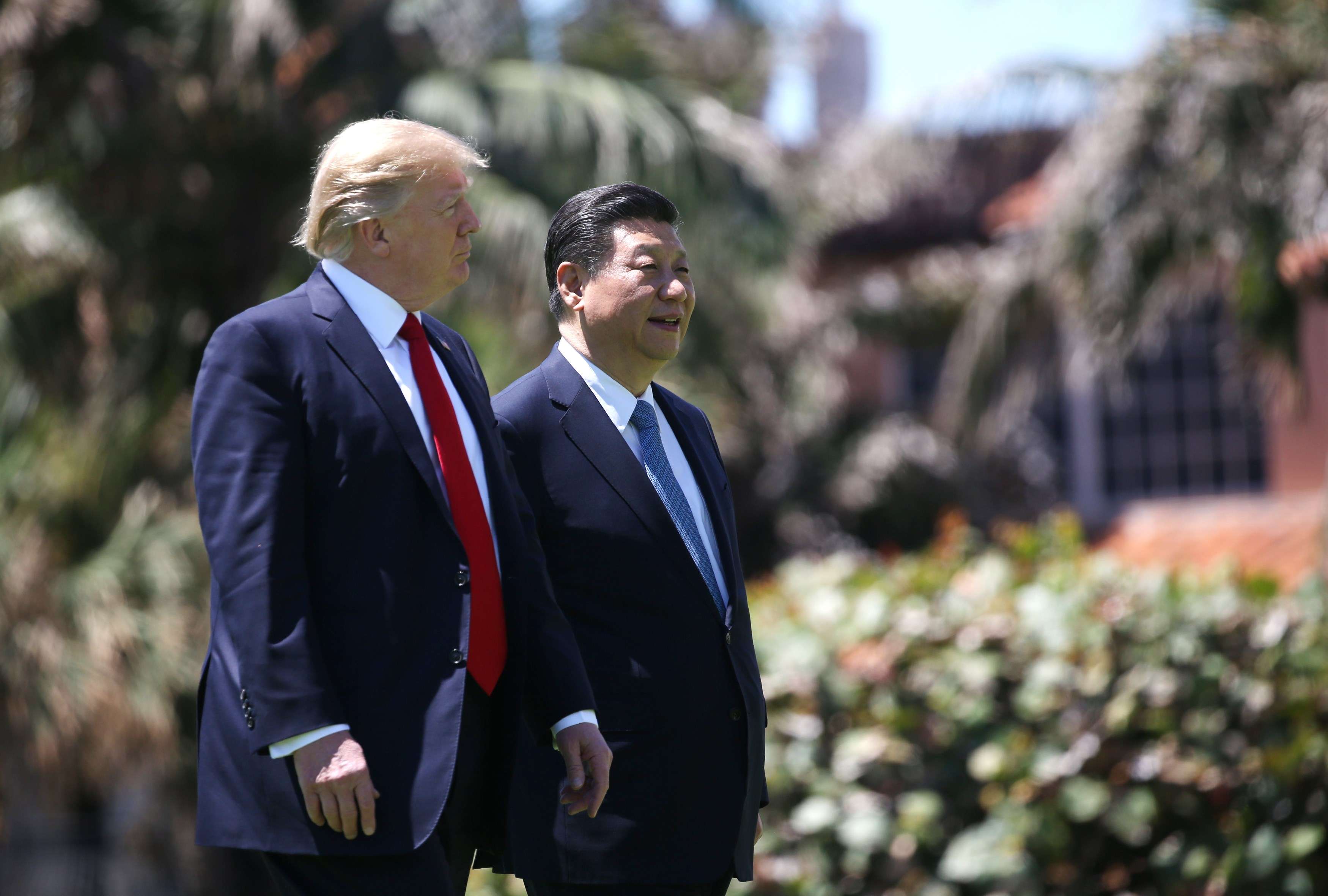 US President Donald Trump and China's President Xi Jinping walk along the front patio of the Mar-a-Lago estate after a bilateral meeting in Palm Beach, Florida, on Thursday. Photo: Reuters
