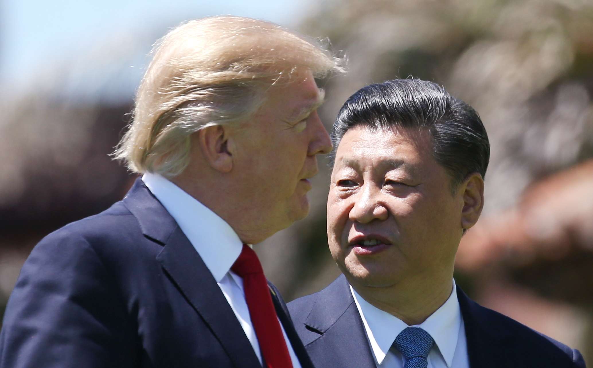 US President Donald Trump and China's President Xi Jinping walk along the front patio of the Mar-a-Lago estate after a bilateral meeting in Palm Beach, Florida on Friday. Photo: Reuters
