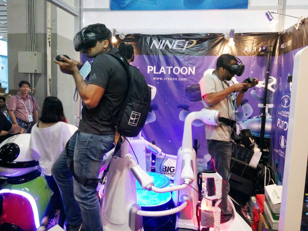 Visitors to the Canton Fair try virtual reality games at the NINED Digital Technology booth. Photo: Mimi Lau