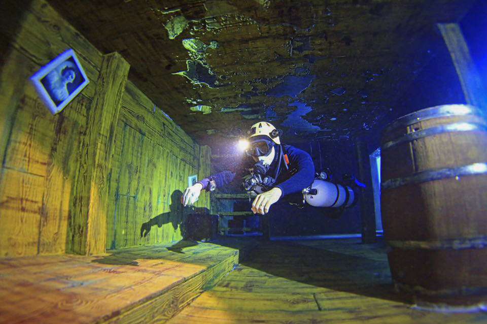 A participant diving in the pool at the Divecube Hotel.