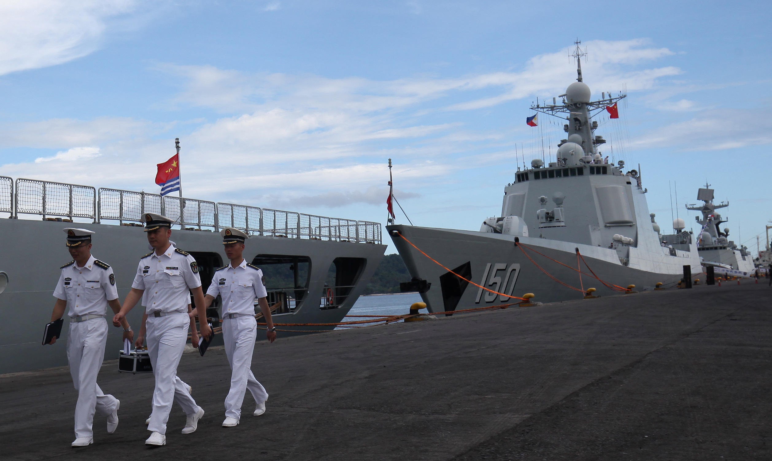 Chinese navy officers walk past a PLA ship during their port call at Davao City in the Philippines. Photo: Reuters
