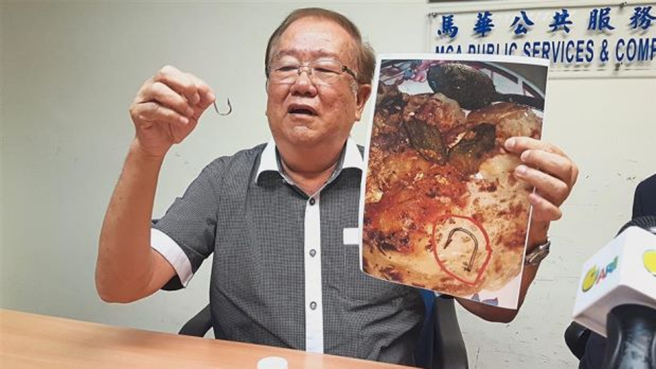 Chong holding up the fish hook he found in the fish head curry from a restaurant in Petaling Jaya. Photo: The Star